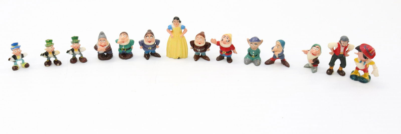 Vintage molded plastic cartoon characters: Description: Walt disney figures including - pinocchio and snow white and the 7 dwarfs - (14) total Condtion: Some wear to surface Size: LARGEST 1 1/2" Consignor: JS Terms: This is an On-Site Onlin