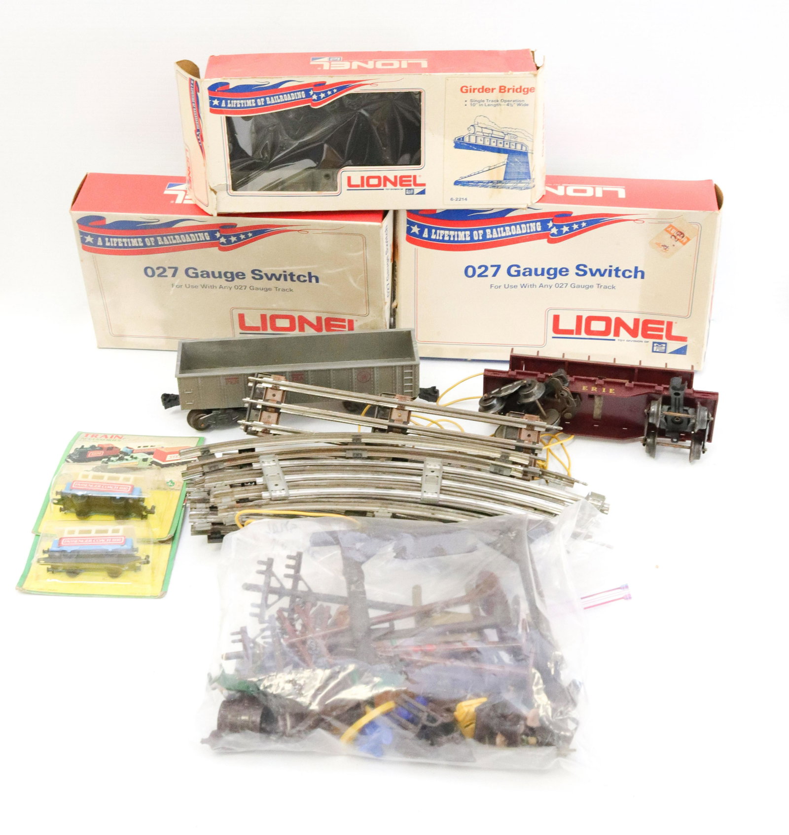 Group lot of train accessories: Description: Including - lionel gauge switch, girder bridge, metal track, and (2) marx train cars Condtion: As found - see photos for description and condition Size: Consignor: JS Terms: This is an
