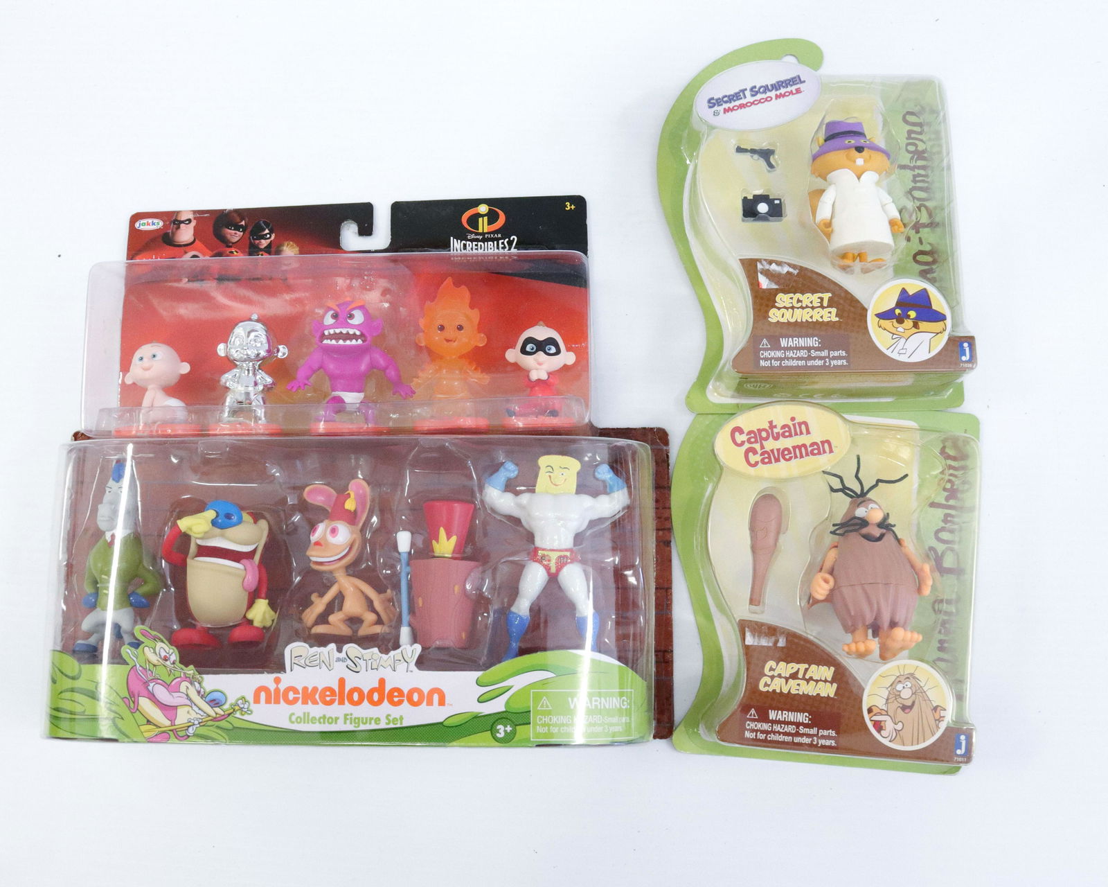 Group lot of toy figures: Description: Unopened toys in original boxes including - ren and stimpy, secret squirrel, captain caveman, and the incredibles ii Condtion: As found - see photos for description and condition Size: Co