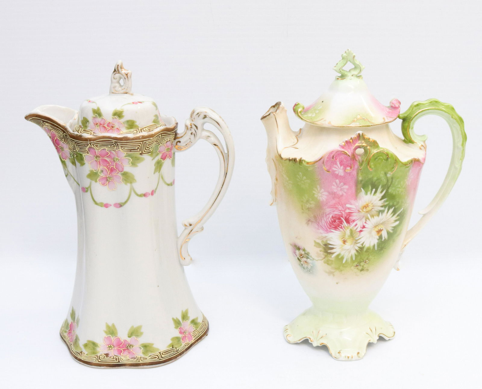 Porcelain chocolate pots: Description: (2) chocolate pots - japan and prussia Condtion: Wear consistent with age and use Size: 9 1/2" X 6 1/2" - 9 3/4" X 6 1/2" Consignor: JS Terms: This is an On-Site Online Only Auction.