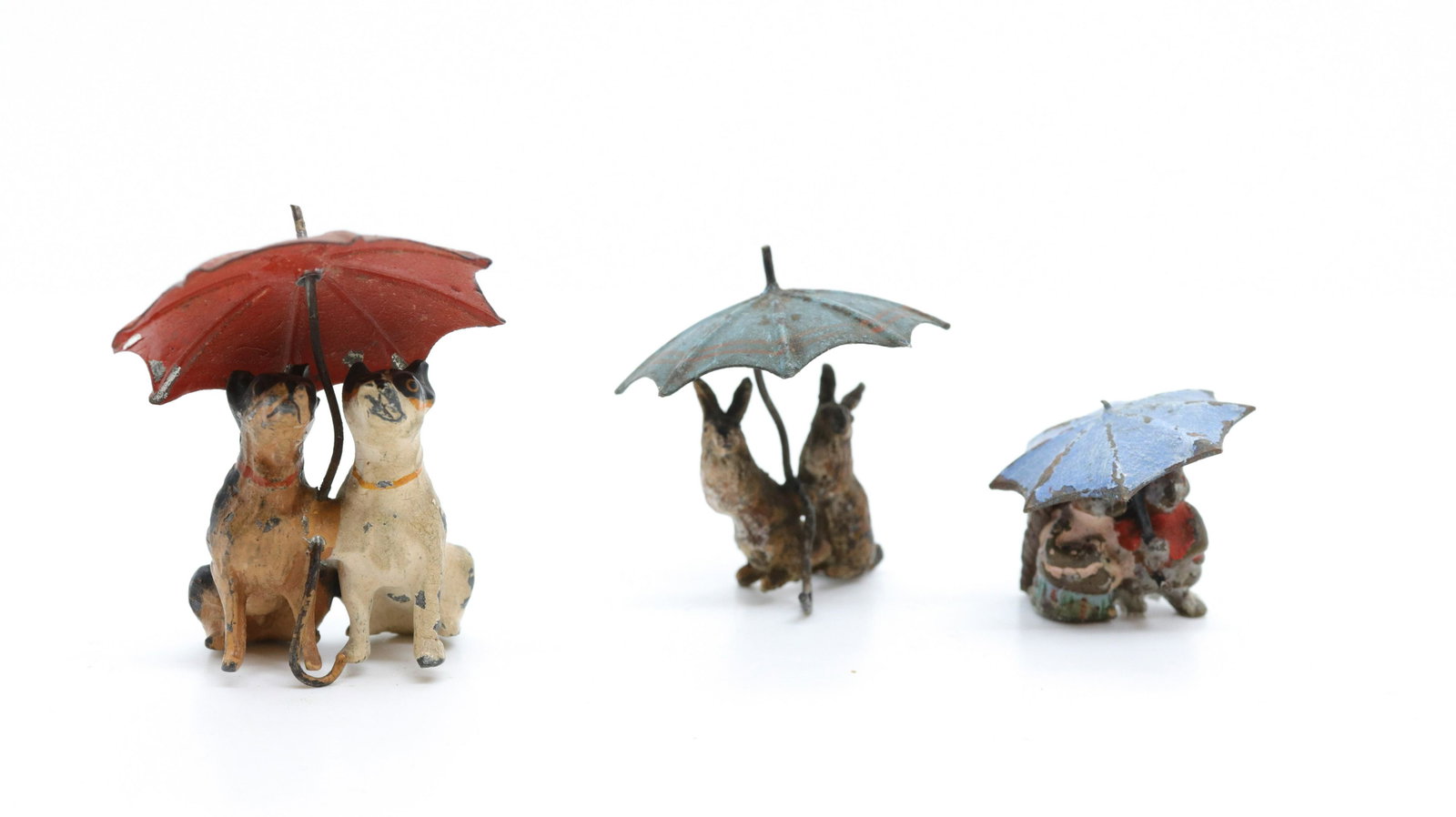 Miniature animals and umbrellas: Description: Vienna bronze pair of squirrels and umbrellas, (2) cast metal dogs with umbrellas, and (2) cast metal rabbits with umbrella - all vintage and in original paint Condtion: Wear consistent w