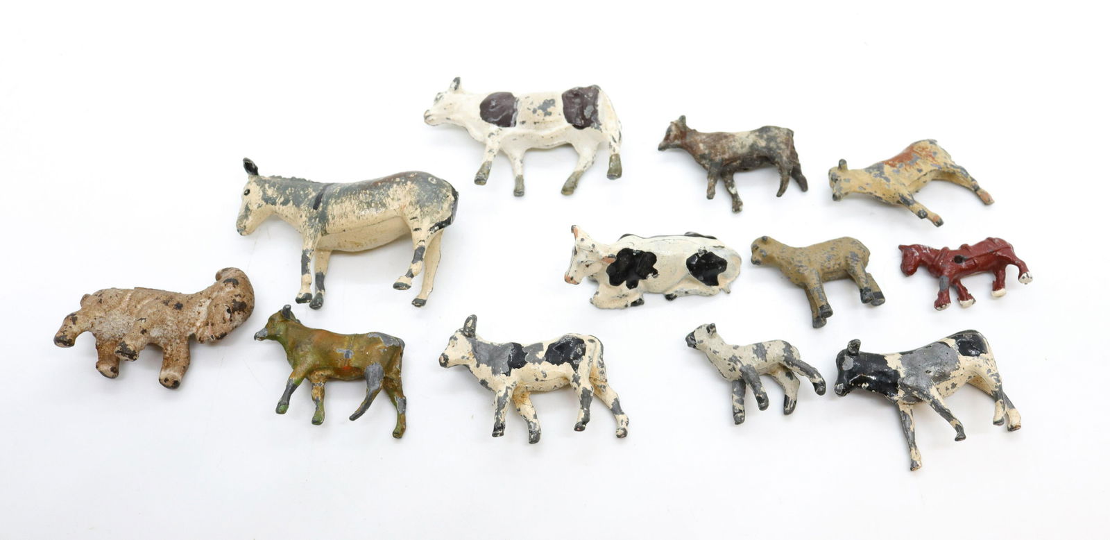 Group lot of miniature farm animals: Description: (12) total including - cast white metal cows, lamb, horse, and early cast iron goat Condtion: Paint loss and wear Size: 1 1/4" Consignor: JS Terms: This is an On-Site Online Only Aucti