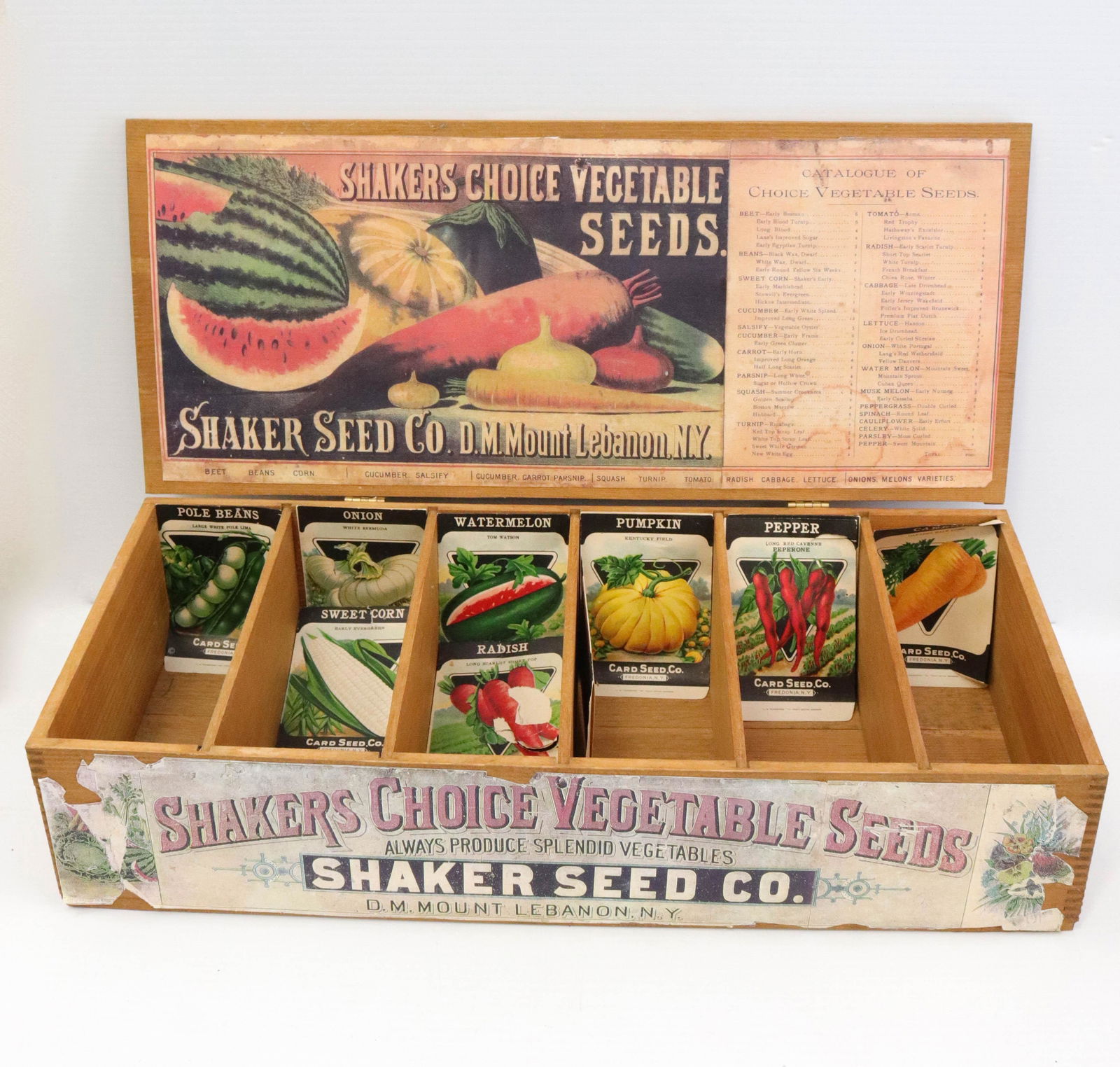 Shakers choice vegetable seed box: Description: Modern lift lid box with interior seed compartments and packets Condtion: Wear consistent with age and use Size: 5" X 9 1/2" X 21 1/2" Consignor: JS Terms: This is an On-Site Online On