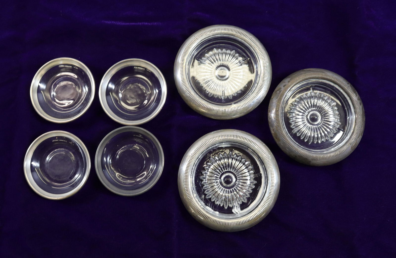GROUP LOT OF GLASS COASTERS AND ASHTRAYS: THREE COASTERS TRIMMED IN STERLING Size COASTERS 4" D