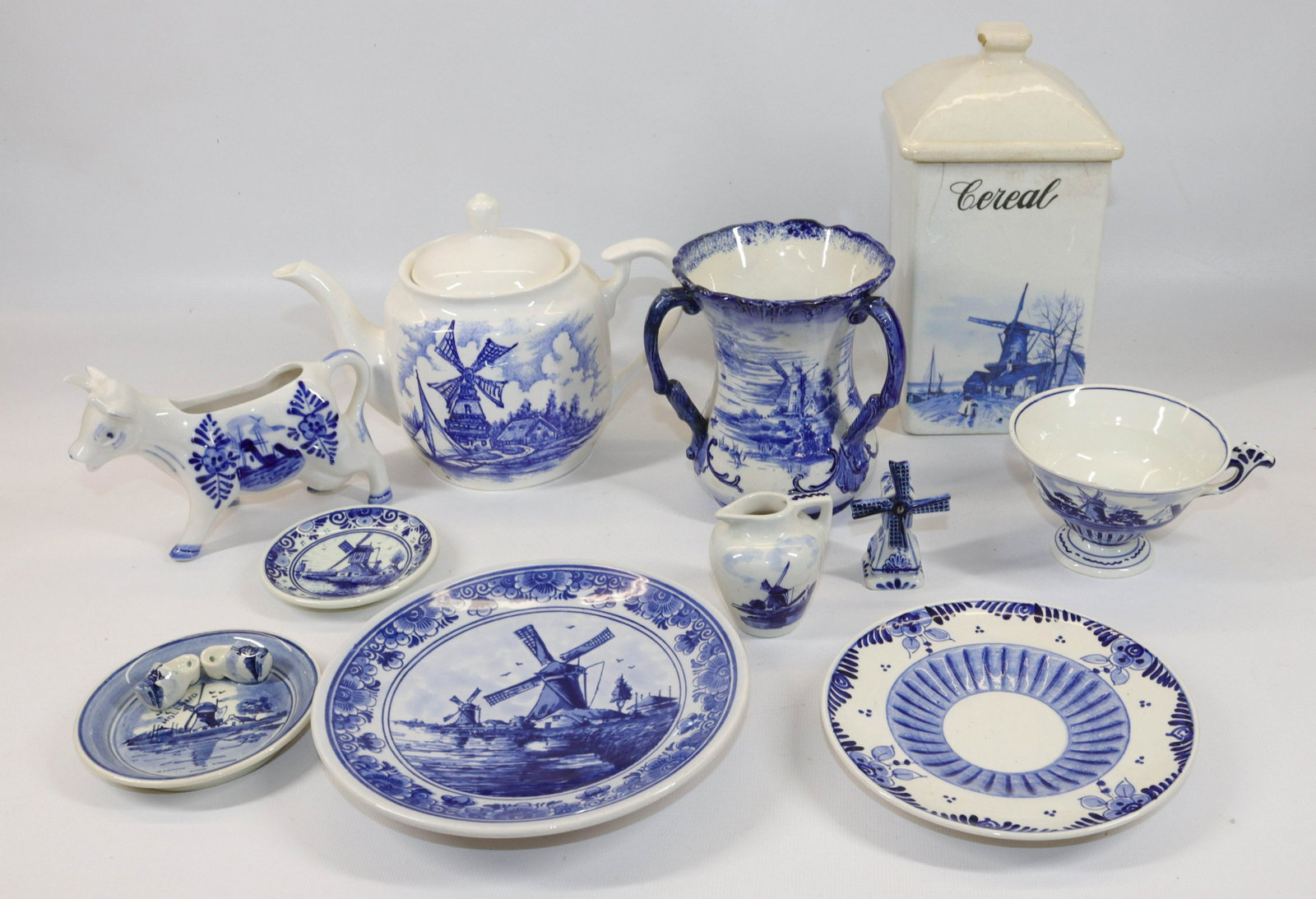 GROUP LOT OF DELFT DISHES: (11) INCLUDING TEAPOT, VASE (MRKD. ENGLAND), SAUCERS, CREAMERS AND MORE Size TEAPOT IS 8 1/2" D