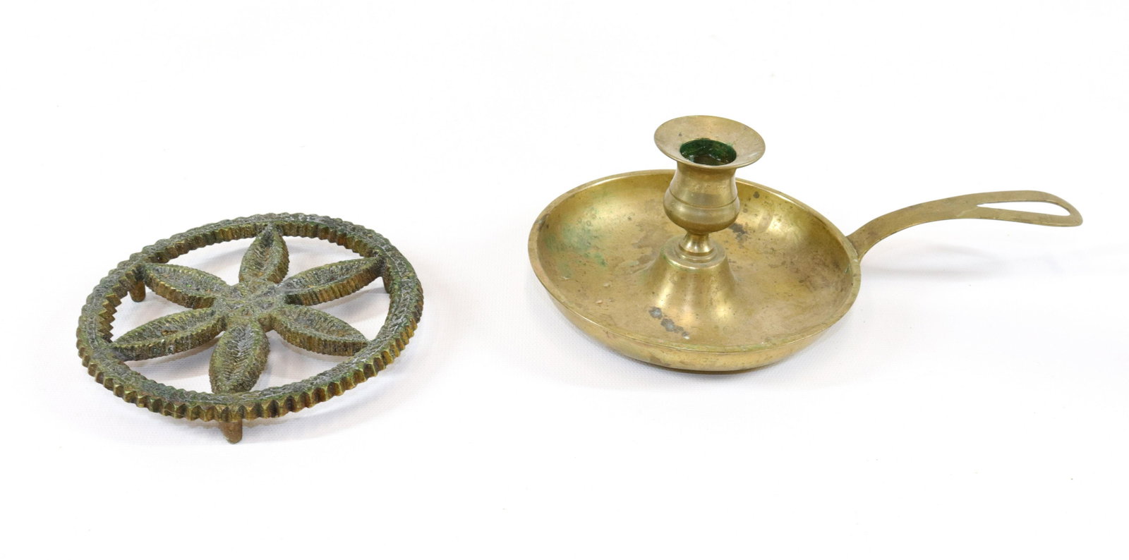 PR. OF BRASS ITEMS: INCLUDING - PINWHEEL MOTIF TRIVET AND HANDLED SAUCER CANDLESTICK - BOTH ARE BRASS SIZE: 5 1/4" AND 9" IN DIAMETERS