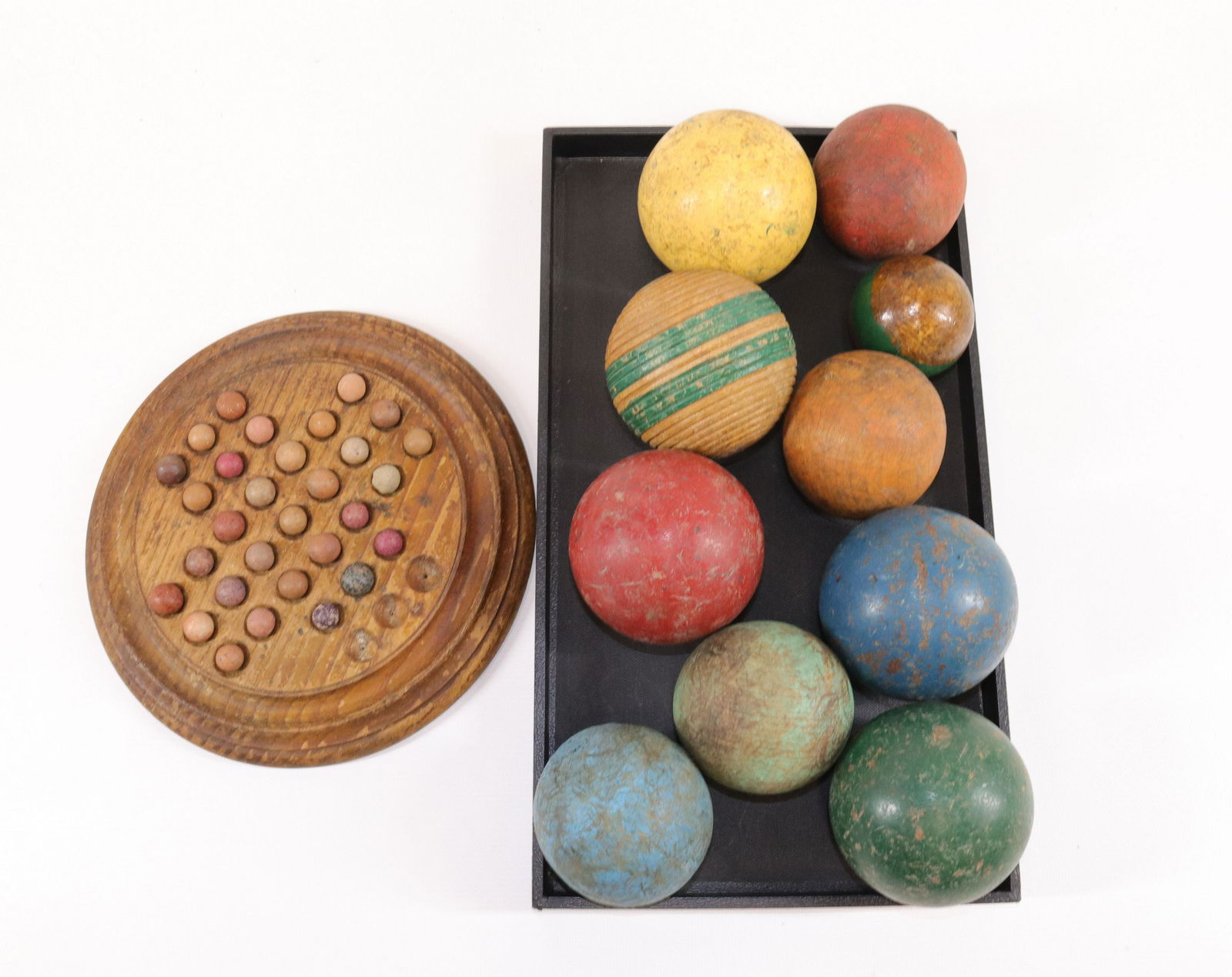 VINTAGE WOODEN MARBLE GAME AND CROQUET BALLS: WOODEN TRAY WITH CLAY MARBLES AND (10) PAINTED WOODEN BALLS SIZE: MARBLE GAME 9" D - BALLS 2 1/4" TO 3 1/2"