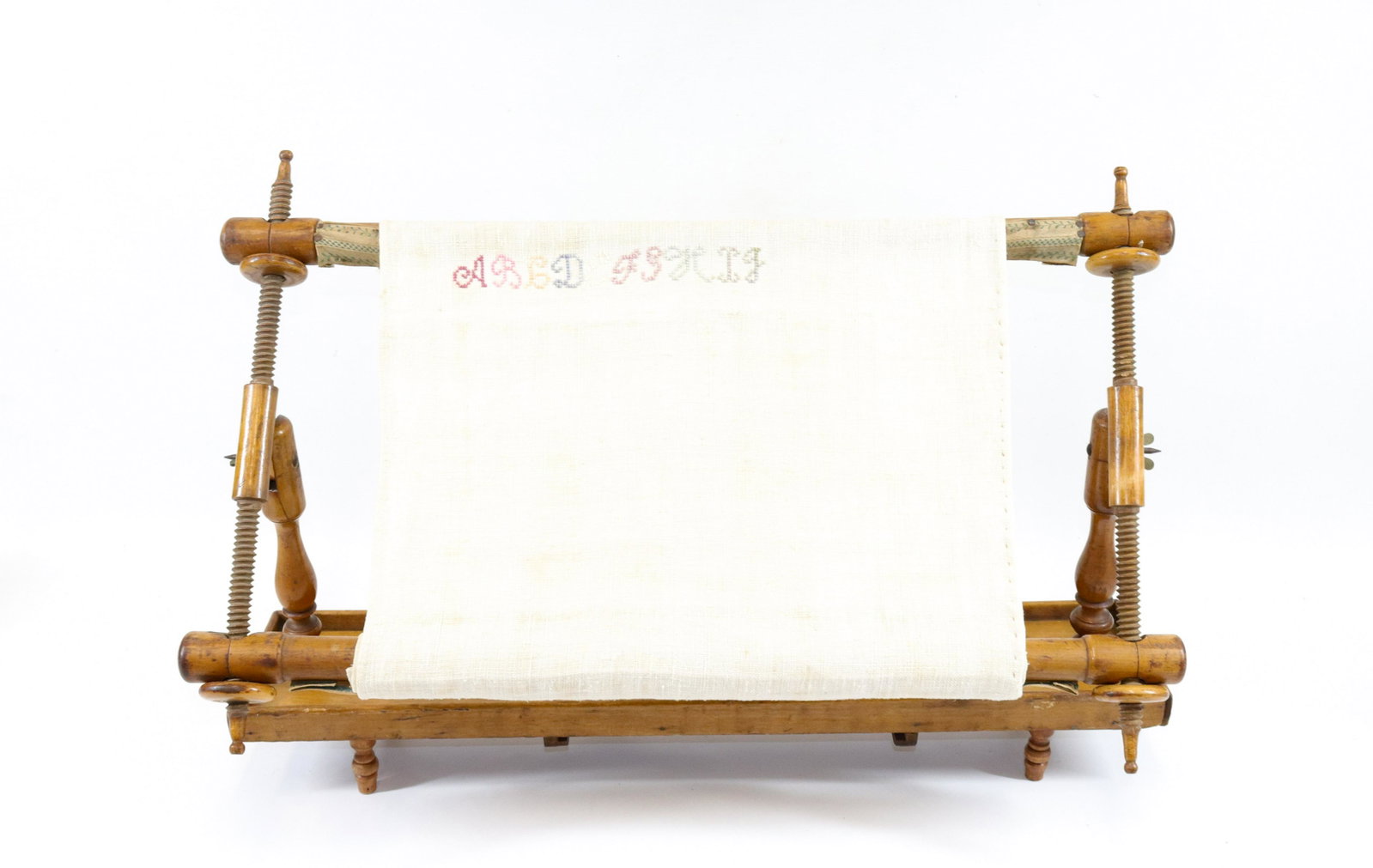 19TH CENTURY ADJUSTABLE SEWING FRAME: TURNED WOODEN CONSTRUCTION WITH PARTIAL SAMPLER SIZE: 15" X 23"