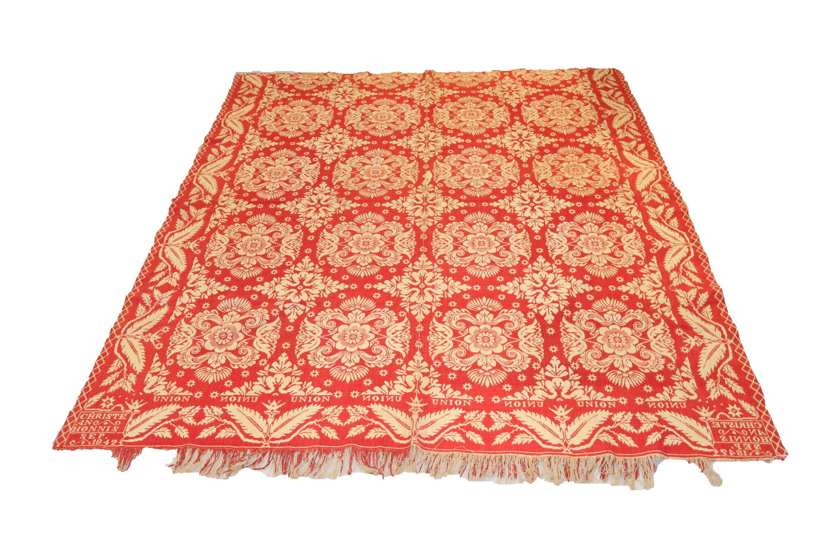 19TH CENTURY WOVEN COVERLET: TWO COLOR (RED/CREAM) - TWO PIECE CONSTRUCTION - MARKED "UNION, CHRISTE. AN HONNIS, SEP. 1842" - FRINGE BOTTOM EDGE AND LEAF BORDER SIZE: 83" X 76"