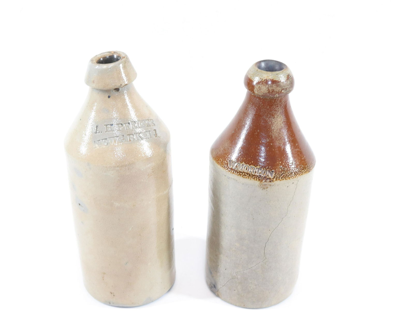 PAIR OF STONEWARE BOTTLES: ONE IMPRESSED "W. MORTON" WITH ALBANY GLAZE AT TOP - OTHER IMPRESSED "A.H. PFEIFER NEWARK, NJ" SIZE: 10" AND 10 1/4" H