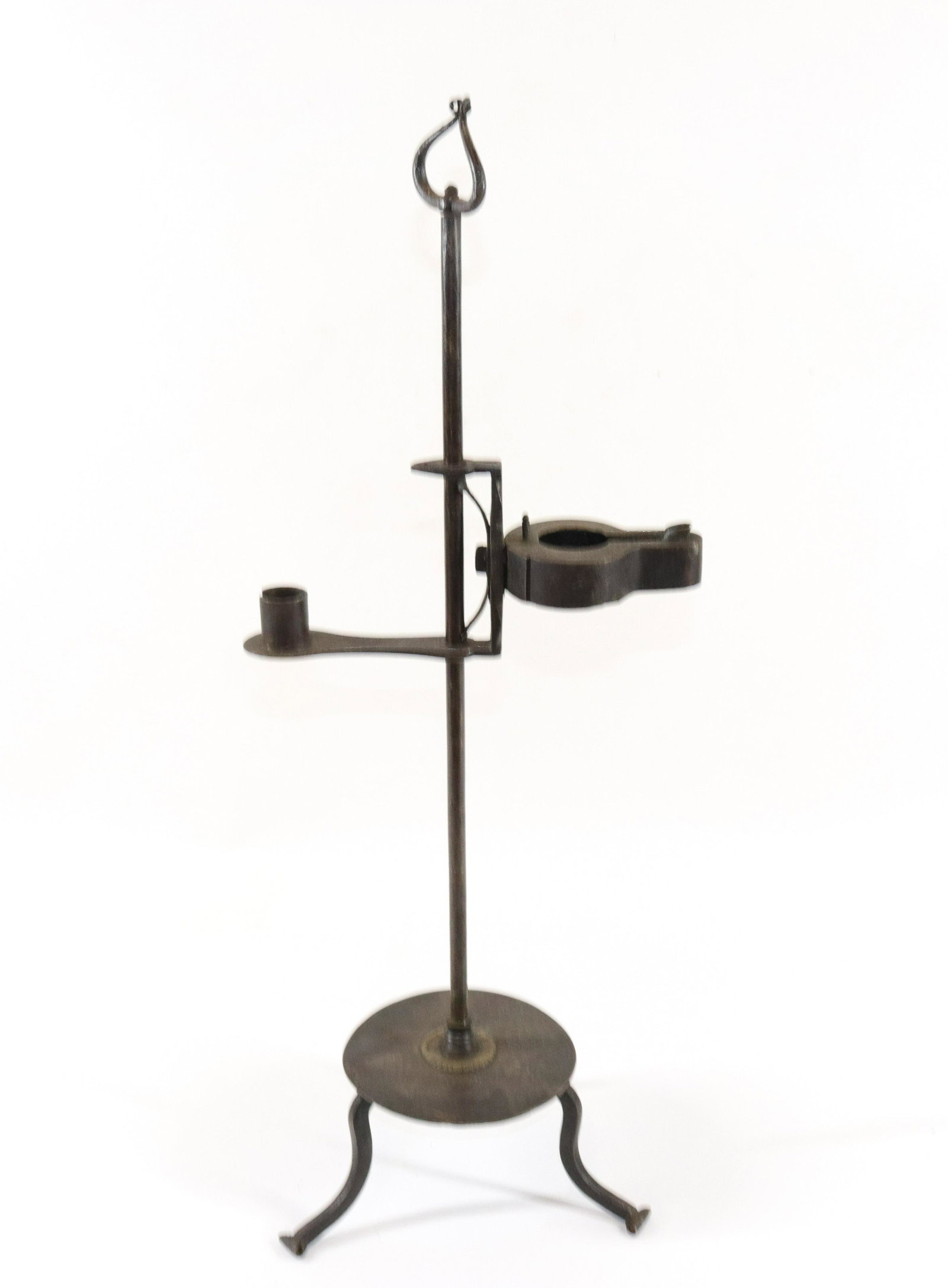 WROUGHT IRON AND BRASS LIGHTING DEVICE: IRON BETTY LAMP AND CANDLE COMBINATION - ADJUSTABLE - BRASS DECORATION ON BASE SIZE: 22" H