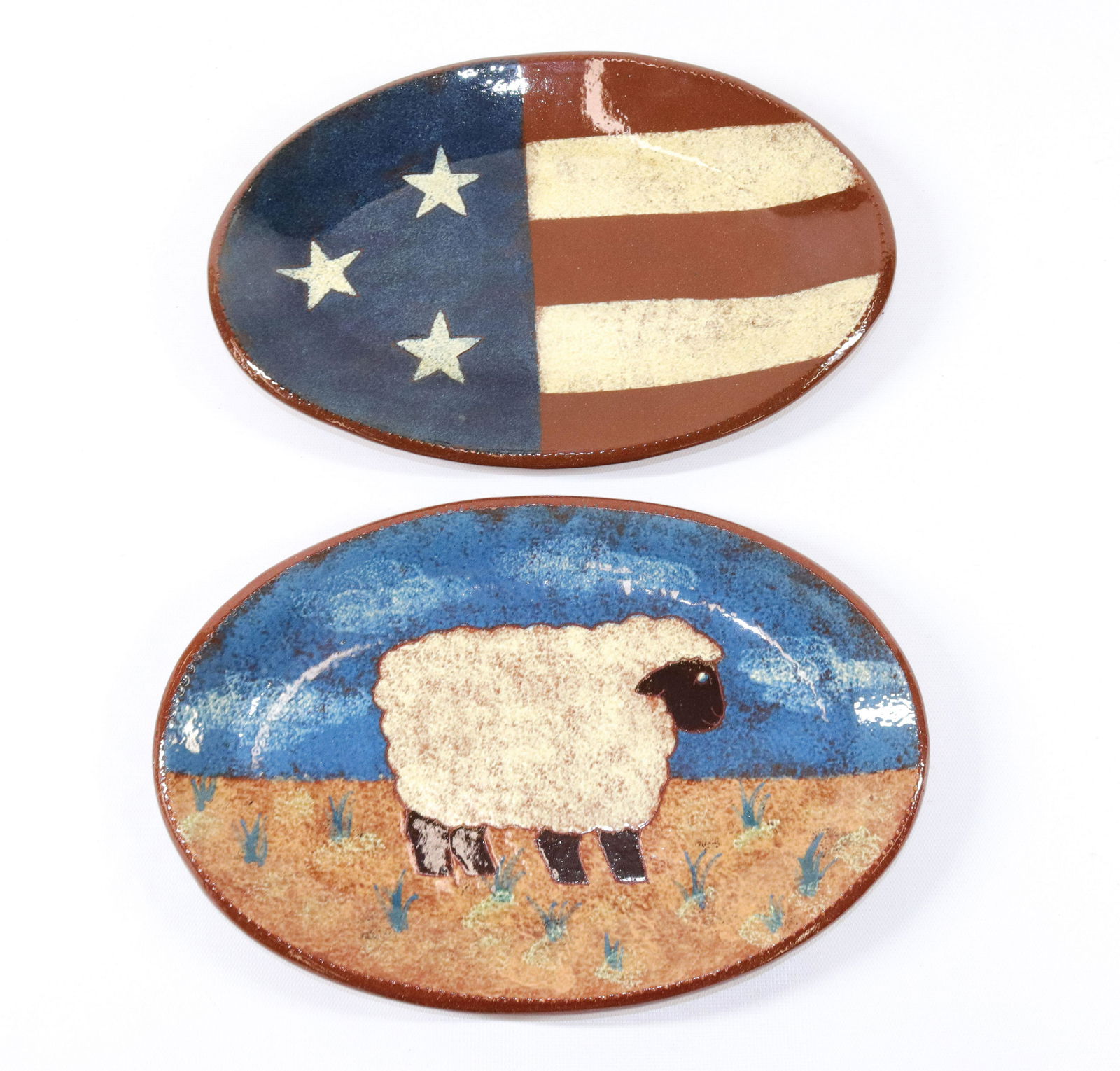 PAIR OF MODERN REDWARE PLATTERS: MARKED "OXFORD EARTHENWARE" - 1997 AND 1999 WITH FLAG AND SHEEP MOTIF SIZE: 11 1/4" X 7 1/2"