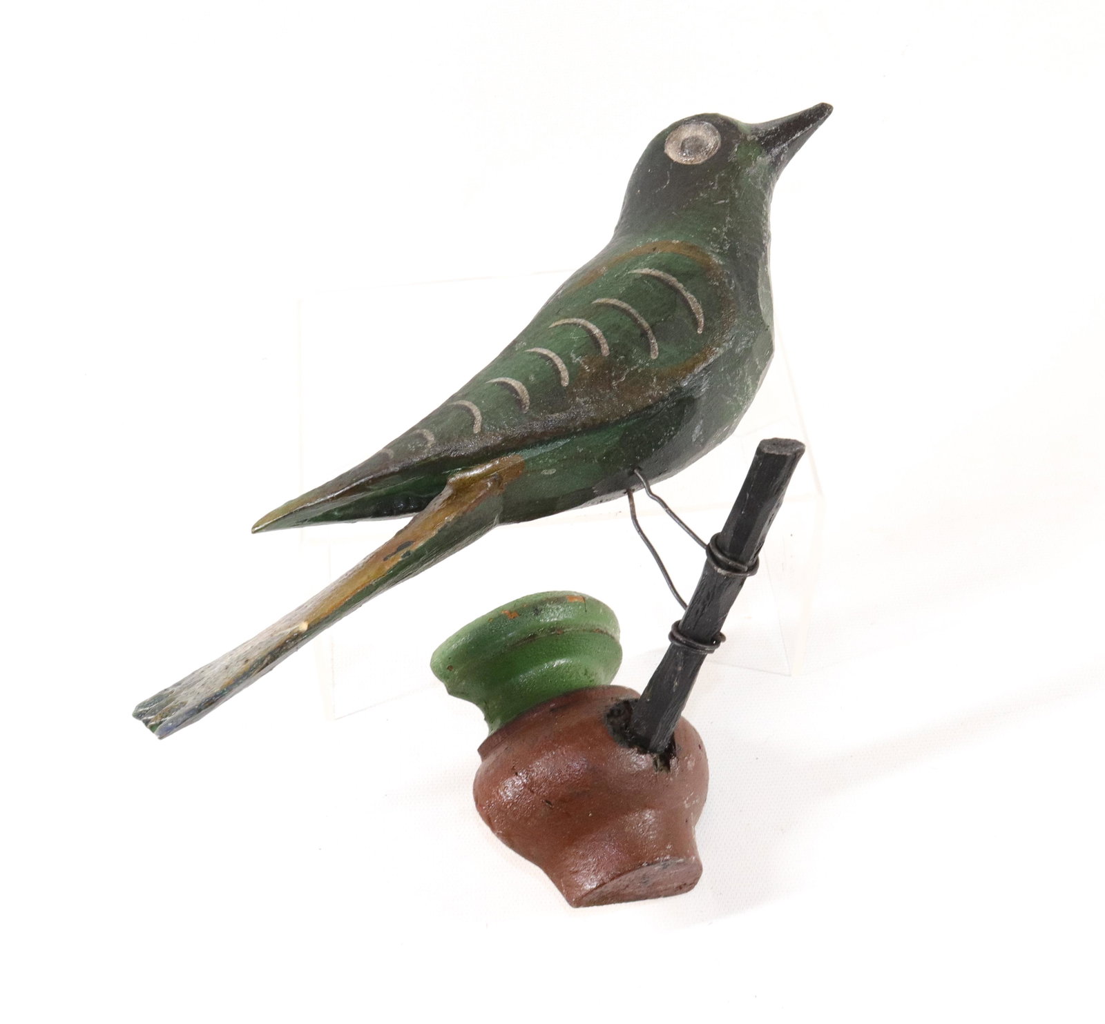 FOLK ART CARVED WOODEN BIRD: HAND CARVED AND PAINTED WITH WIRE LEGS ON WOODEN PERCH SIZE: BIRD 11" L