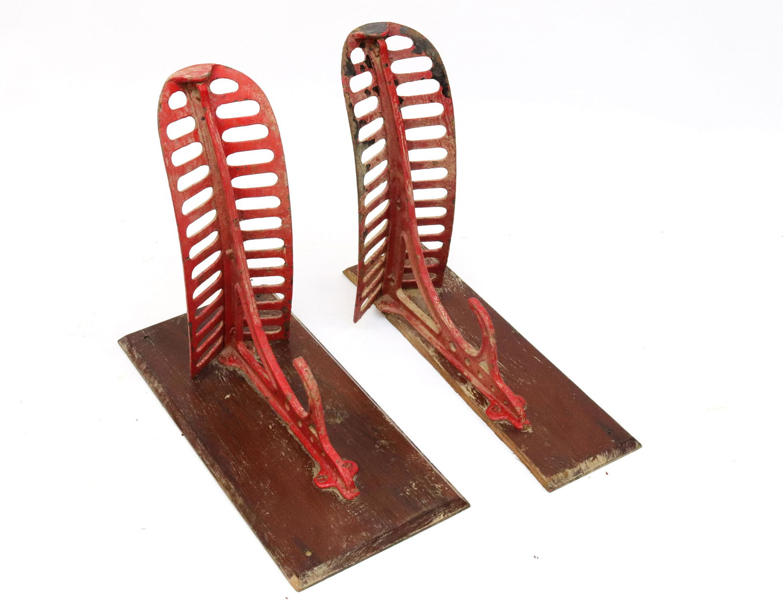 PR. OF CAST IRON SADDLE HOLDERS: CAST IRON PAINTED RED AND MOUNTED ON WOODEN BACKING SIZE: HOLDER 16" X 8"X 19"