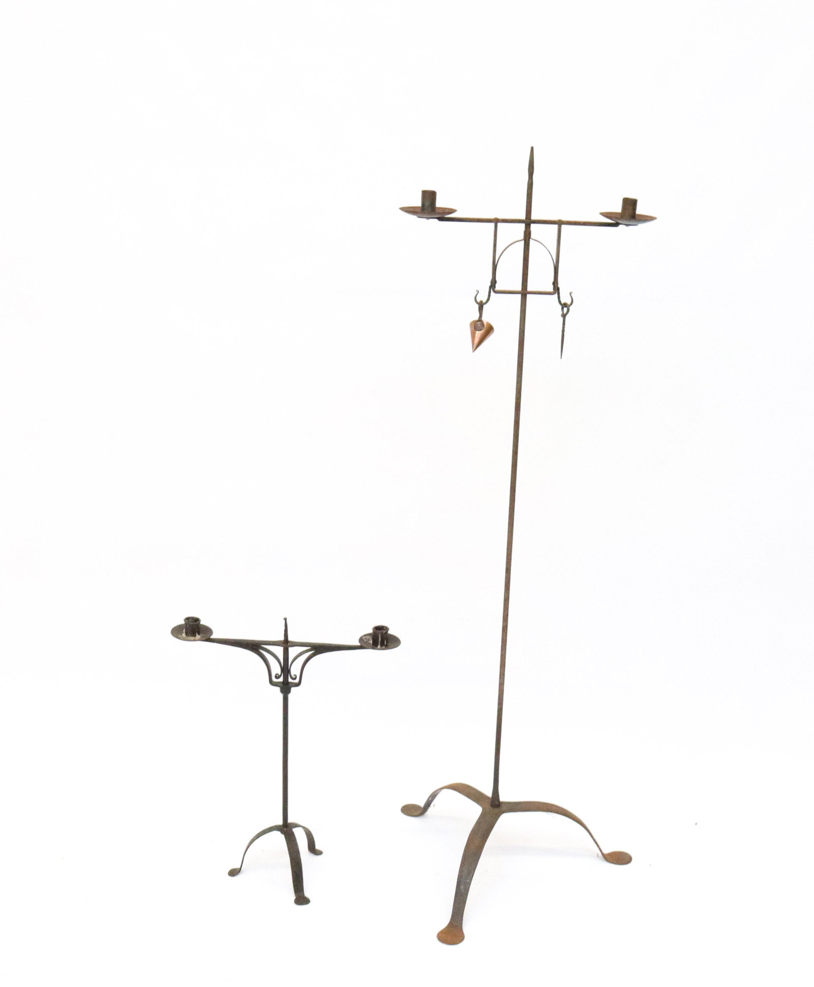 PAIR OF WROUGHT IRON LIGHTING DEVICES: INCLUDING: DOUBLE CANDLE HOLDER FLOOR LIGHT (ADJUSTABLE WITH PICK AND SNUFFER). TABLE TOP DOUBLE CANDLE HOLDER WITH DECORATED SURFACE SIZE: 19" H AND 48 1/2" H
