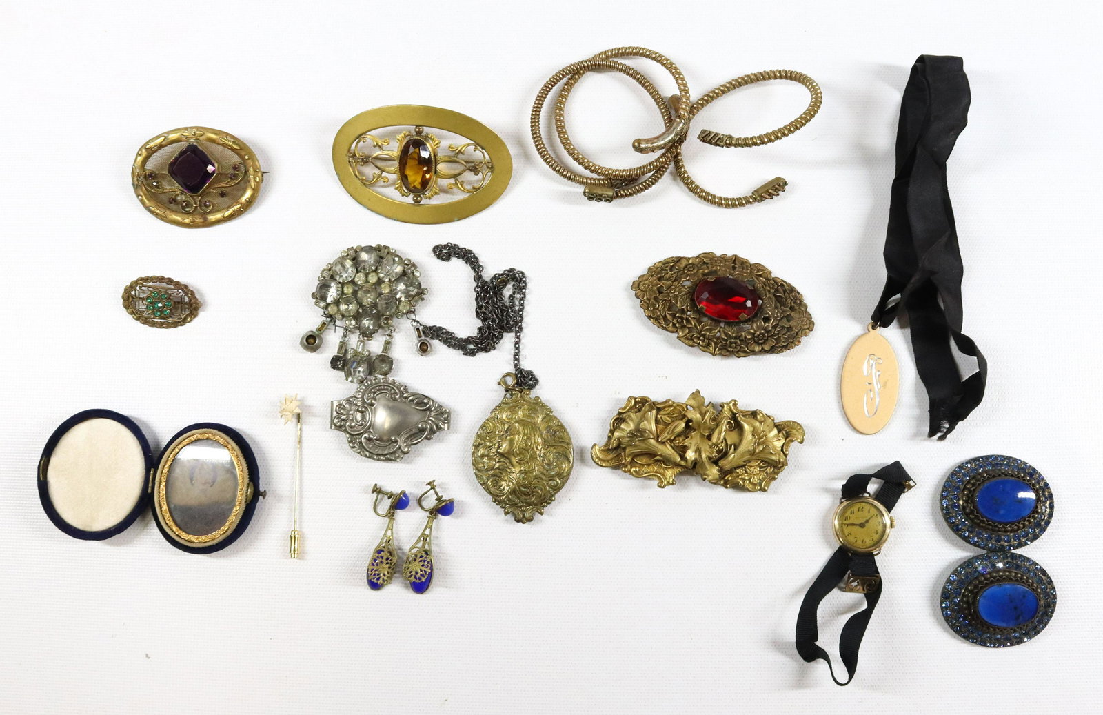 VICTORIAN JEWELRY LOT: 3 LARGE BRASS BROOCHES WITH GLASS STONES, 3 SPRING BANGLES, BRASS PENDANT, RHINESTONE BUCKLE, BRASS BUCKLE, CHATELAINE CLIP, AMBROTYPE IMAGE VELVET CASE