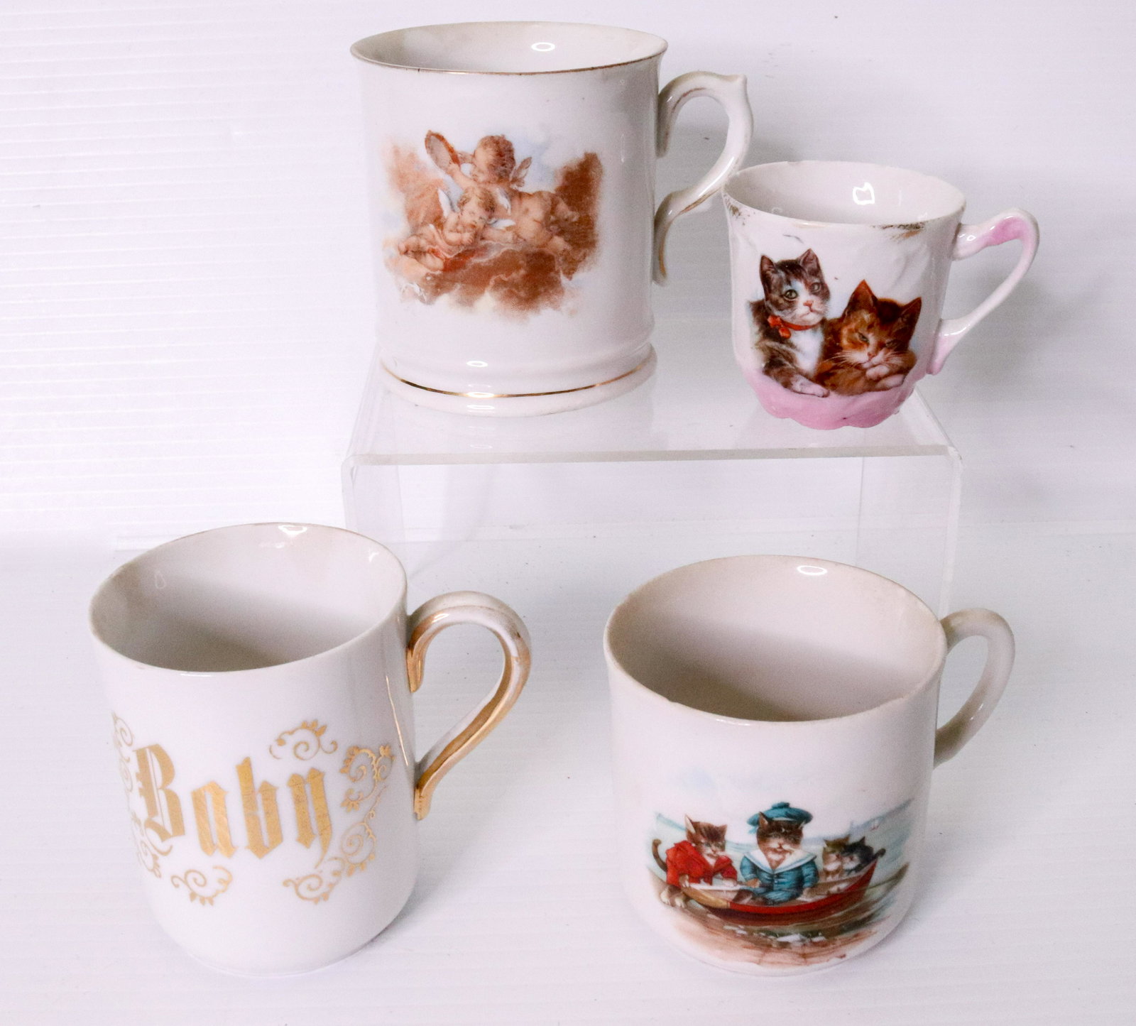 SHAVING MUG AND CHILD MUG LOT: (4) INCLUDING - ONE WITH CHERUB MOTIF, ONE MARKED "BABY", ONE WITH CATS IN A ROW BOAT, AND ONE WITH PAIR OF CATS