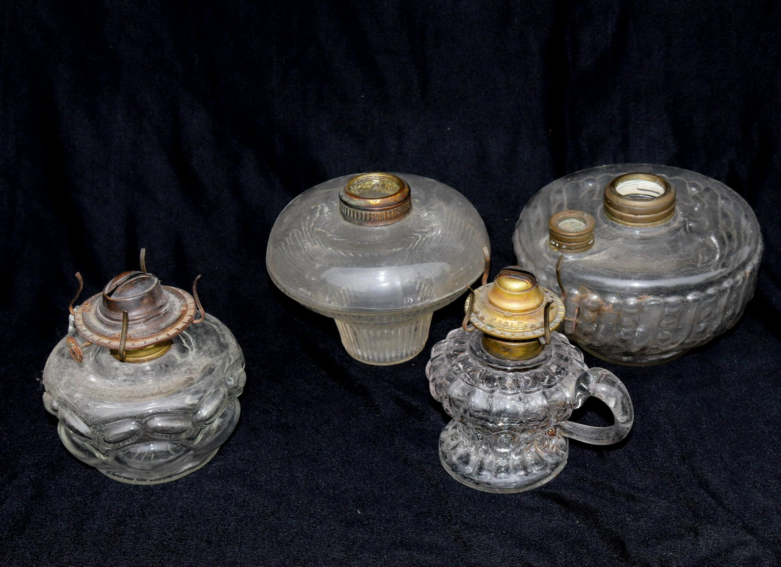 ANTIQUE OIL LAMP LOT: (4) OIL LAMPS - (2) THUMB HOLES SIZE: 4 1/2"X 6" - 5" X 5" TERMS: THIS SALE WILL BE ONLINE ONLY. PICK-UP WILL BE ON-SITE AT 14 CHURCH ST. BETHLEHEM, PA 18018 - APPOINTMENTS WILL BE MADE AS PARKING IS 