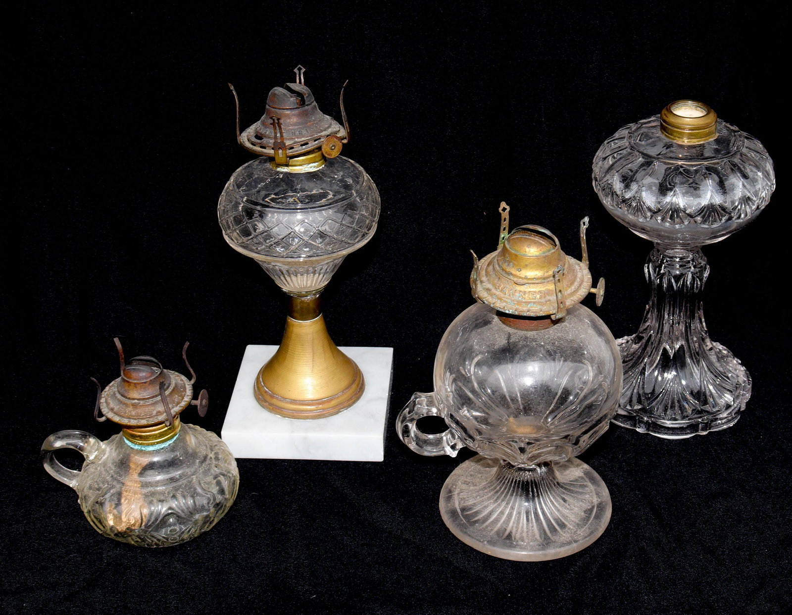 ANTIQUE OIL LAMP LOT: (4) ANTIQUE PATTERN GLASS OIL LIGHTS SIZE: 9 1/2" X 4" - 4 1/2" X 5" TERMS: THIS SALE WILL BE ONLINE ONLY. PICK-UP WILL BE ON-SITE AT 14 CHURCH ST. BETHLEHEM, PA 18018 - APPOINTMENTS WILL BE MADE AS P