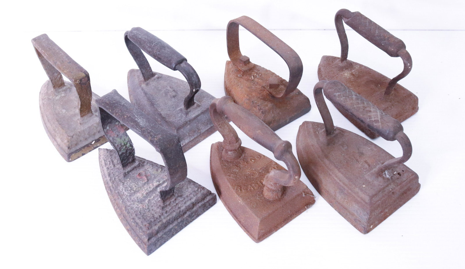 (7) CAST IRON SAD IRONS: ONE MRKD. H.B.& CO. READING, PA. HEAVY WEIGHT ITEMS SIZE: AVERAGE 6" L TERMS: THIS SALE WILL BE ONLINE ONLY. PICK-UP WILL BE ON-SITE AT 14 CHURCH ST. BETHLEHEM, PA 18018 - APPOINTMENTS WILL BE MADE AS