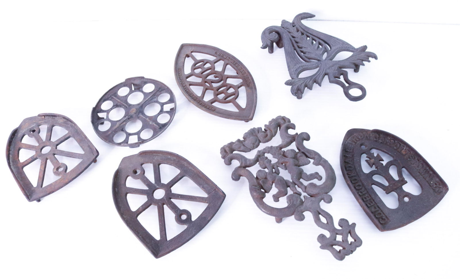 (7) CAST IRON TRIVETS (1 of 4)