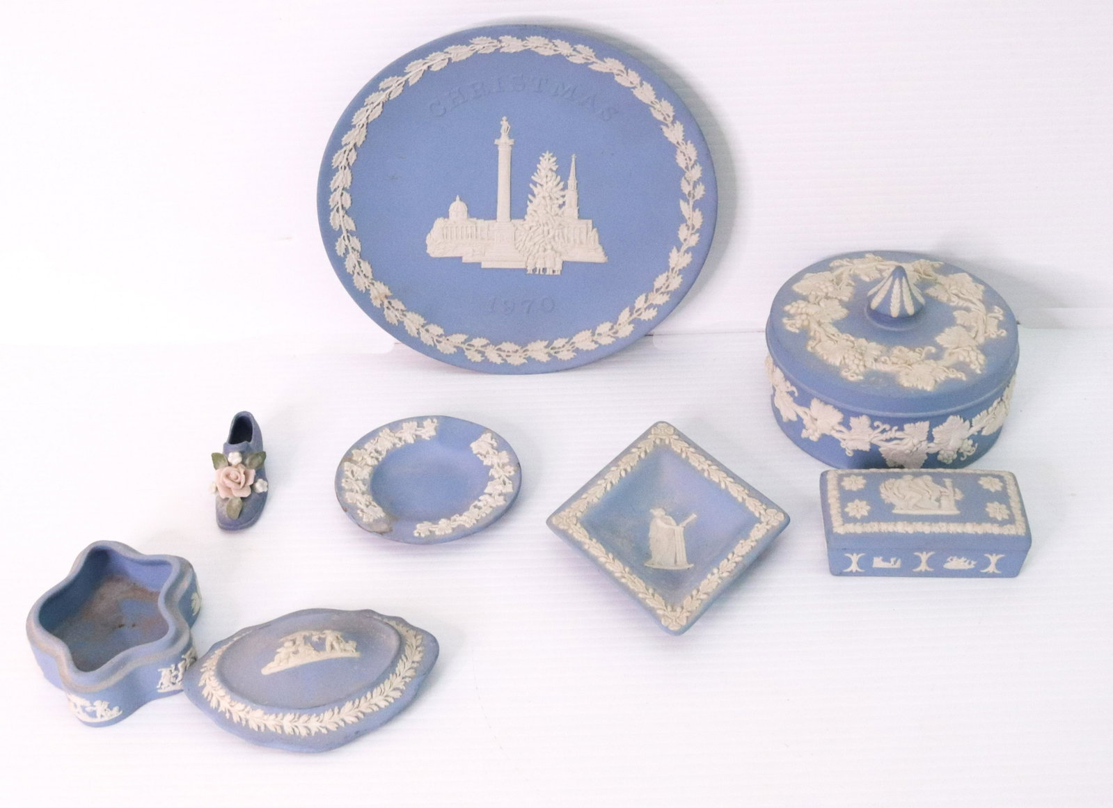 GROUP LOT OF WEDGWOOD JASPERWARE: BLUE AND IVORY.INCLUDING FIVE COMPLETE PIECES. EXTRA LID AND EXTRA BOTTOM TO A CONTAINER. ALSO UNMARKED SHOE WITH FLOWERS SIZE: CHRISTMAS 1970 PLATE 8" D TERMS: THIS SALE WILL BE ONLINE ONLY. PICK-UP 