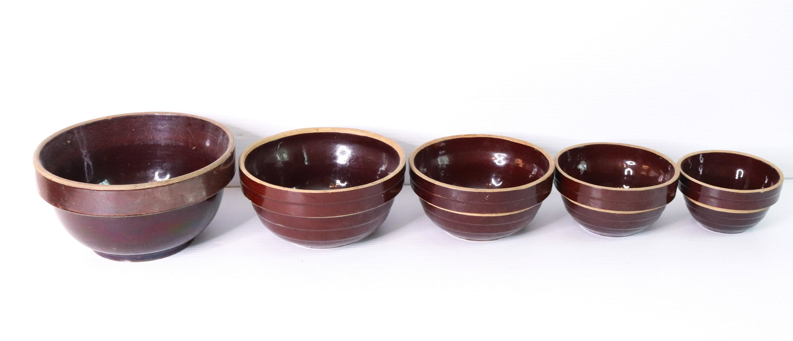 NEST OF VINTAGE MIXING BOWLS: (5) BROWN GLAZE POTTERY BOWLS MRKD. USA SIZE: 5" TO 9" D TERMS: THIS SALE WILL BE ONLINE ONLY. PICK-UP WILL BE ON-SITE AT 14 CHURCH ST. BETHLEHEM, PA 18018 - APPOINTMENTS WILL BE MADE AS PARKING IS VE