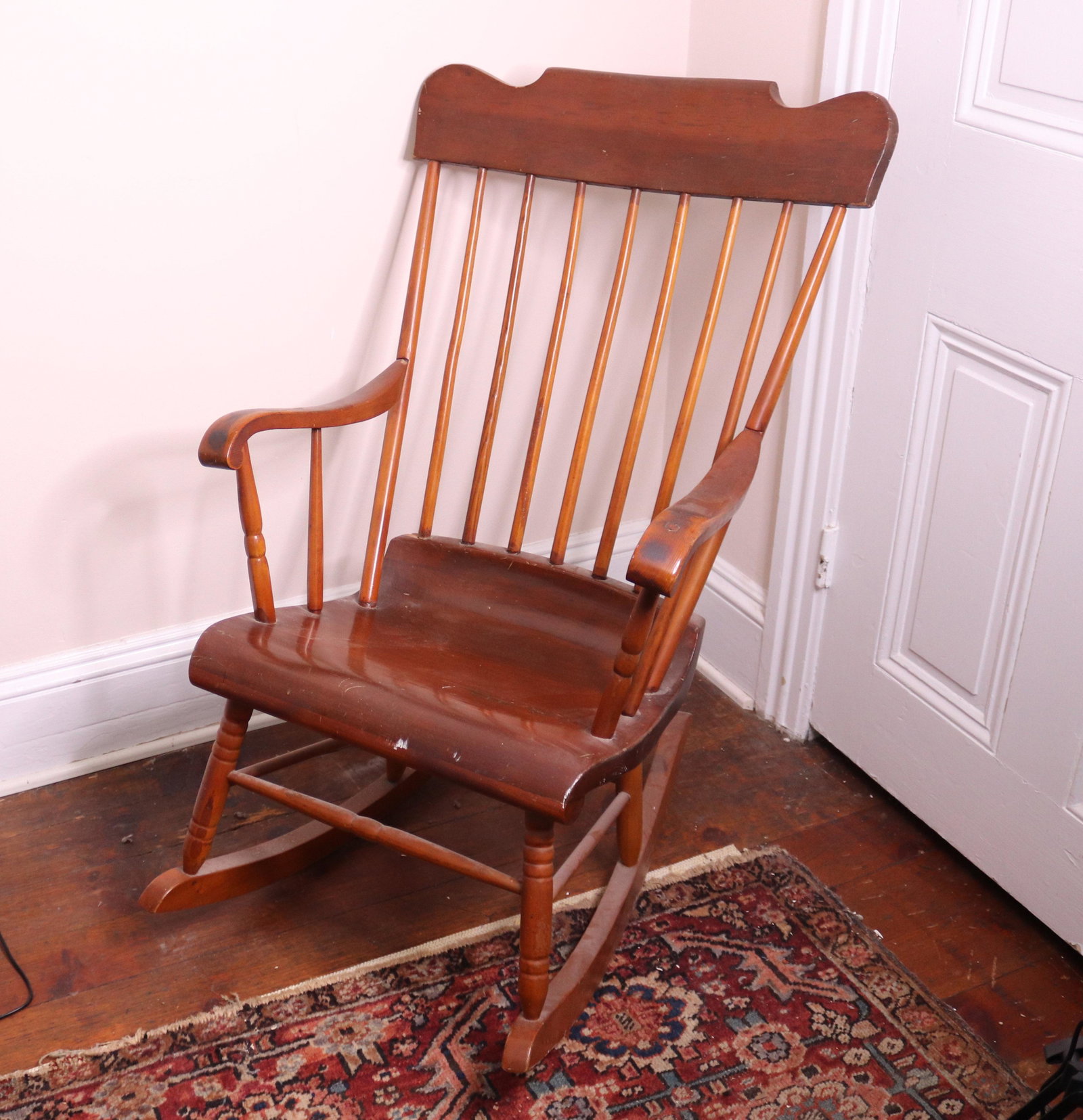 ANTIQUE WOODEN ROCKING CHAIR: SPINDLE BACK. OLD REFINISHED SURFACE SIZE: 36" X 20" X 18" TERMS: THIS SALE WILL BE ONLINE ONLY. PICK-UP WILL BE ON-SITE AT 14 CHURCH ST. BETHLEHEM, PA 18018 - APPOINTMENTS WILL BE MADE AS PARKING IS 
