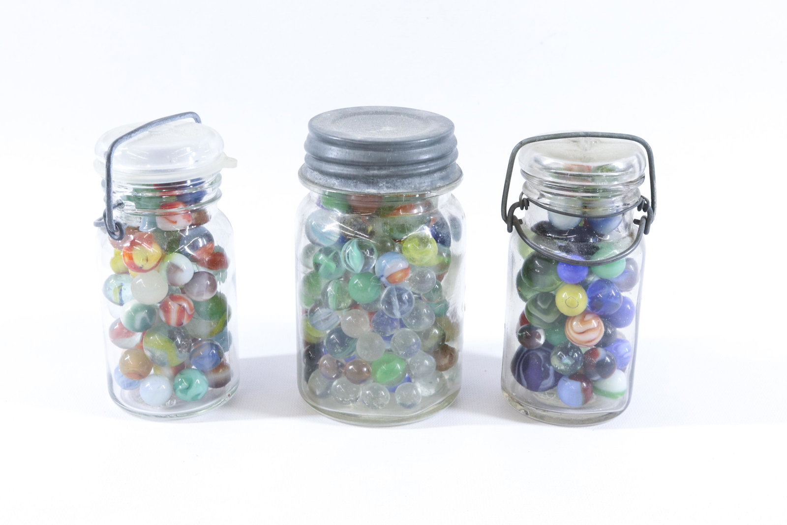 GROUP OF VINTAGE MARBLES: THREE JARS OF VARIOUS MARBLES SIZE: 5" TO 5 1/2" H