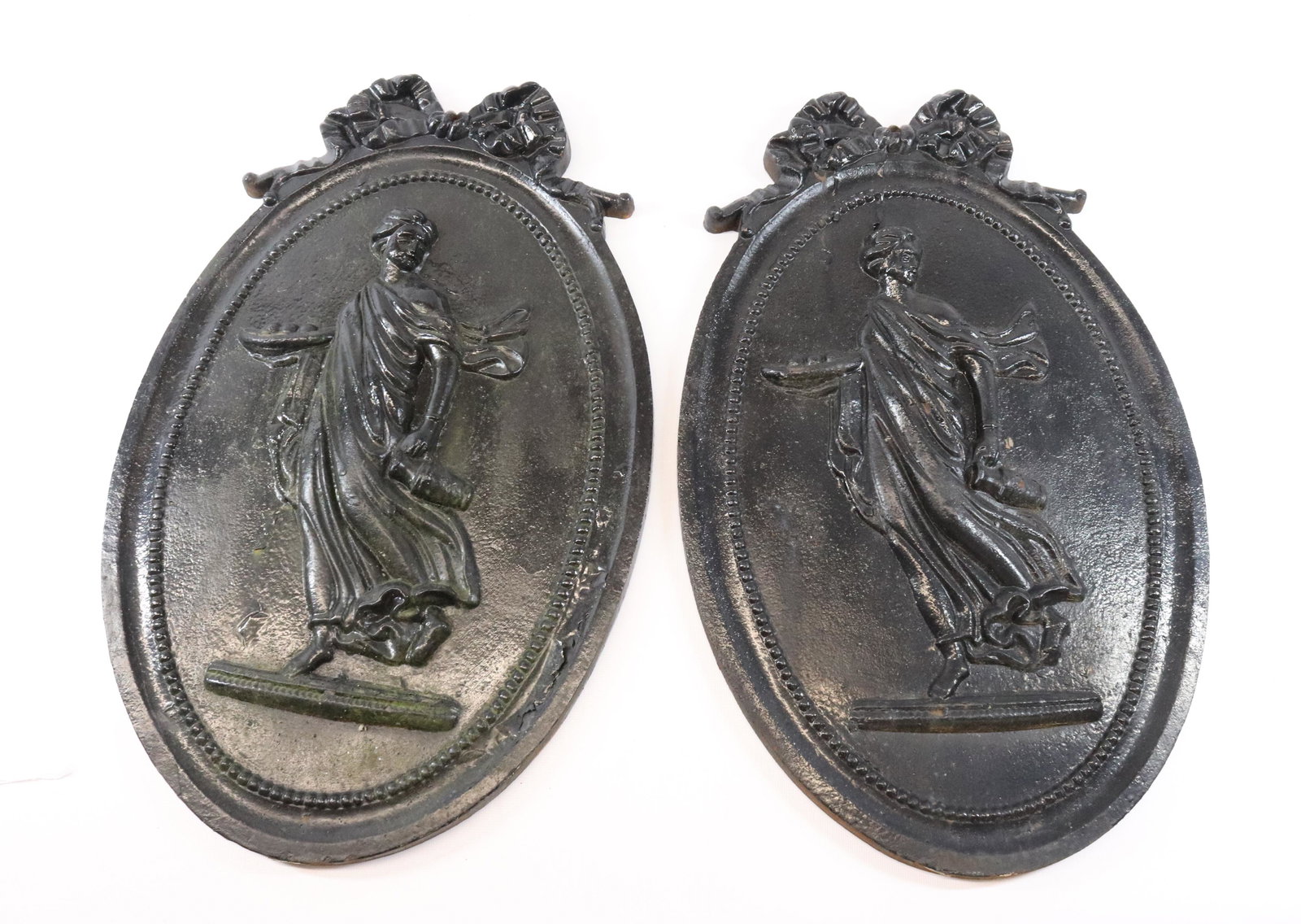 PR. OF CAST IRON WALL PLAQUES: RELIEF DESIGN WITH BLACK PAINTED SURFACE Dimensions 20" X 12" PLEASE READ BEFORE BIDDING – PICKUP FOR THIS AUCTION WILL NOT BE UNTIL THE WEEK OF OCTOBER 25TH. PICK-UP WILL BE FROM 9:00AM TILL 4: