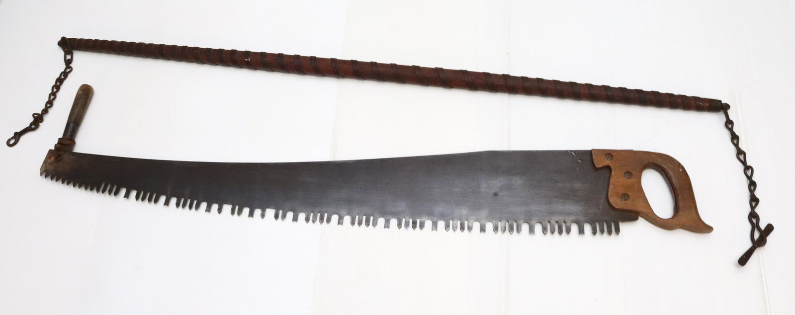 EARLY SAW AND TOOL LOT: ANTIQUE ICE SAW AND IRON BOUND WOODEN ROD Dimensions SAW 53" L - ROD 58" L PLEASE READ BEFORE BIDDING – PICKUP FOR THIS AUCTION WILL NOT BE UNTIL THE WEEK OF OCTOBER 25TH. PICK-UP WILL BE FROM 9