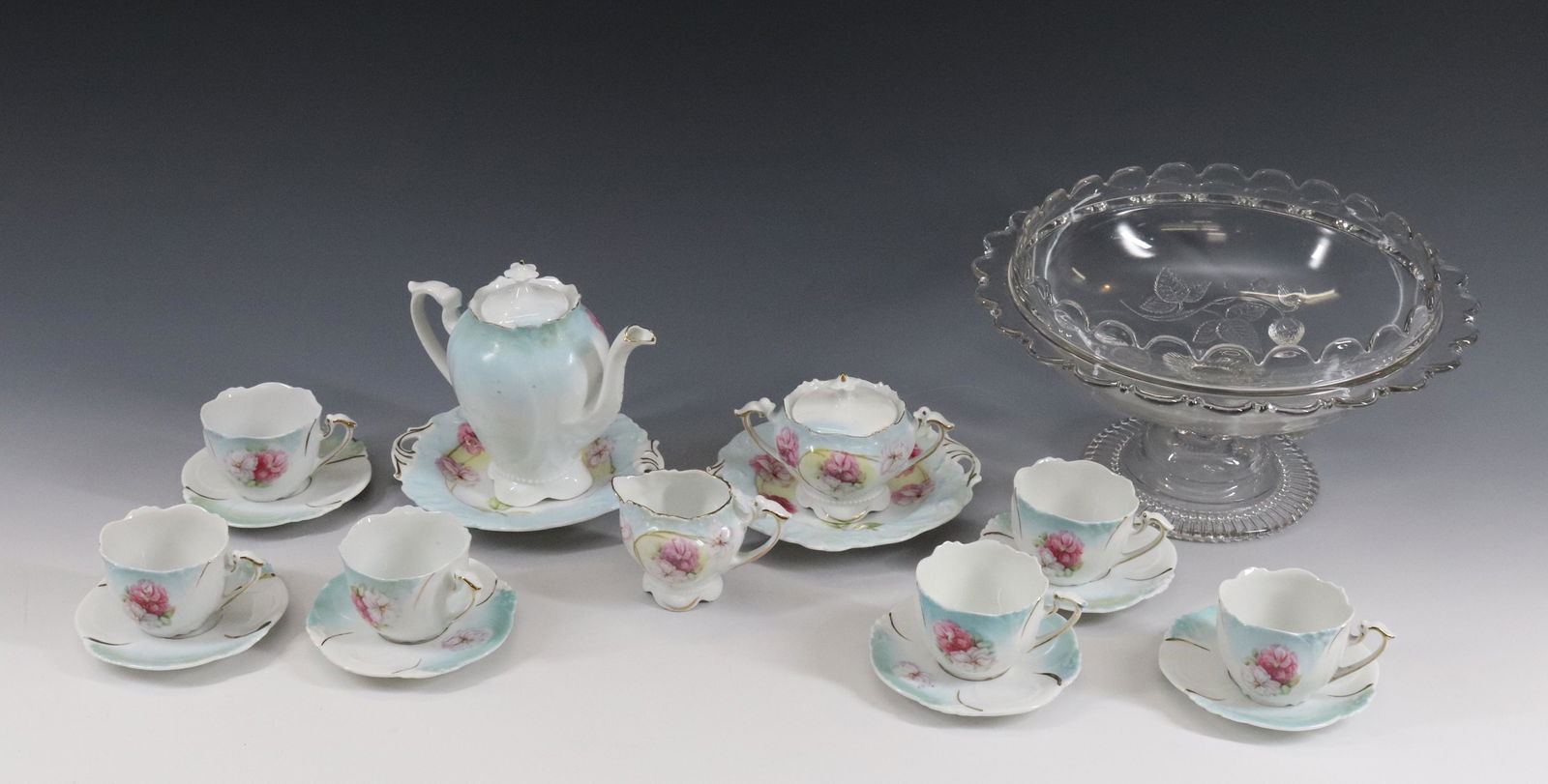 GERMAN PORCELAIN CHILD'S TEA SET: (6) CUPS AND SAUCERS, TEAPOT, SUGAR, AND CREAMER - (2) BISCUIT TRAYS Dimensions TEAPOT 5" X 6" - CUPS 2 1/4" X 3 1/2" PLEASE READ BEFORE BIDDING – PICKUP FOR THIS AUCTION WILL NOT BE UNTIL THE W