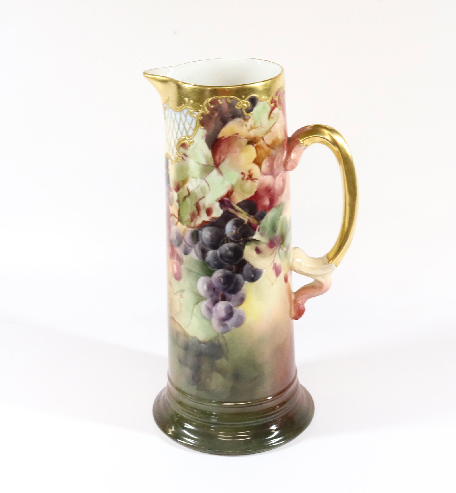 J.P. LIMOGE PORCELAIN PITCHER: HAND PAINTED WITH GRAPEVINE AND LATTICE PATTERN Dimensions 13 3/4" X 6 1/4" PLEASE READ BEFORE BIDDING – PICKUP FOR THIS AUCTION WILL NOT BE UNTIL THE WEEK OF OCTOBER 25TH. PICK-UP WILL BE FROM 