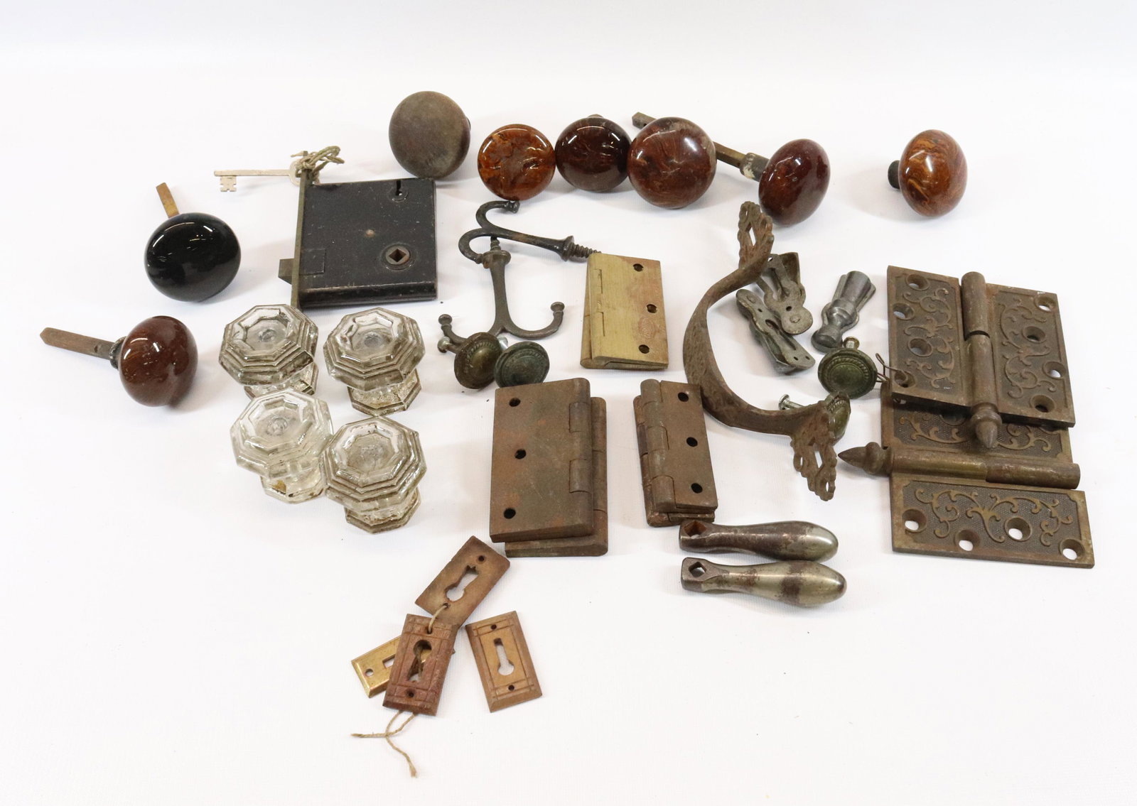 GROUP LOT OF ANTIQUE HARDWARE: INCLUDING 1870S HINGES, GLASS KNOBS, POTTERY KNOBS, KEYHOLE SURROUNDS AND MORE Dimensions GLASS KNOBS 2" D. PLEASE READ BEFORE BIDDING – PICKUP FOR THIS AUCTION WILL NOT BE UNTIL THE WEEK OF OCT