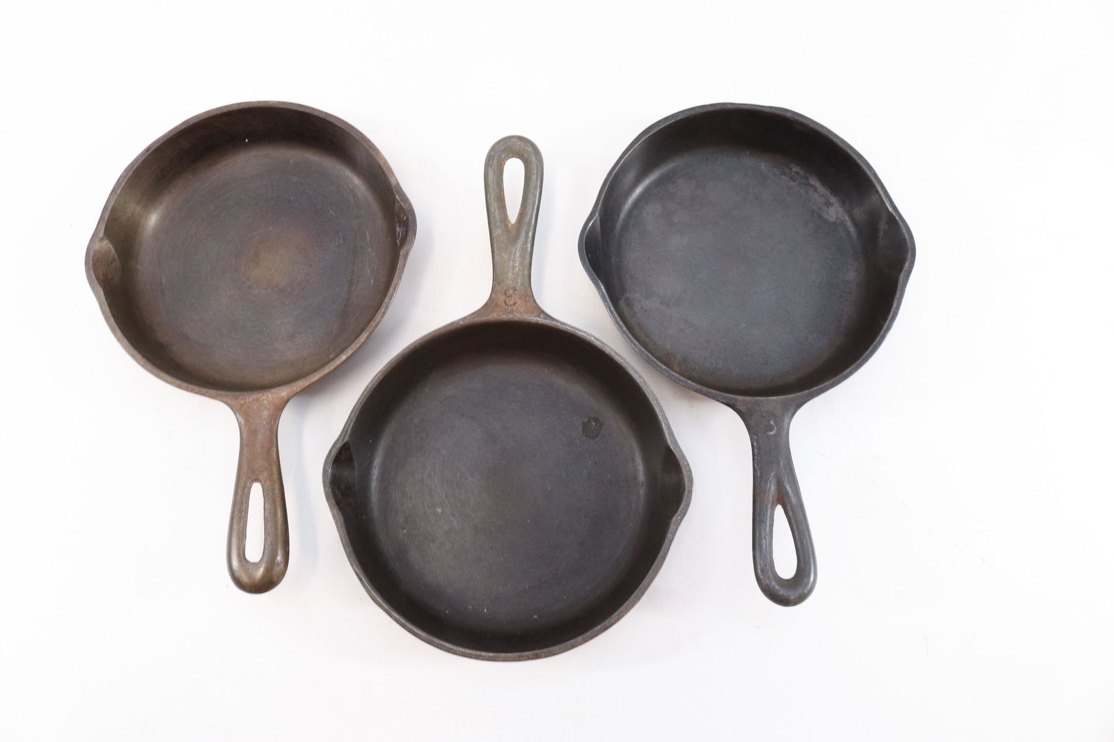 GROUP LOT OF WAGNER WARE SKILLETS: TWO WAGNER WARE SIDNEY "0". ONE MARKED 1053H AND THE OTHER 1053 0. THIRD SKILLET MARKED. 6 1/2 INCH SKILLET MADE IN USA Dimensions 6 1/2" D PLEASE READ BEFORE BIDDING – PICKUP FOR THIS AUCTION W
