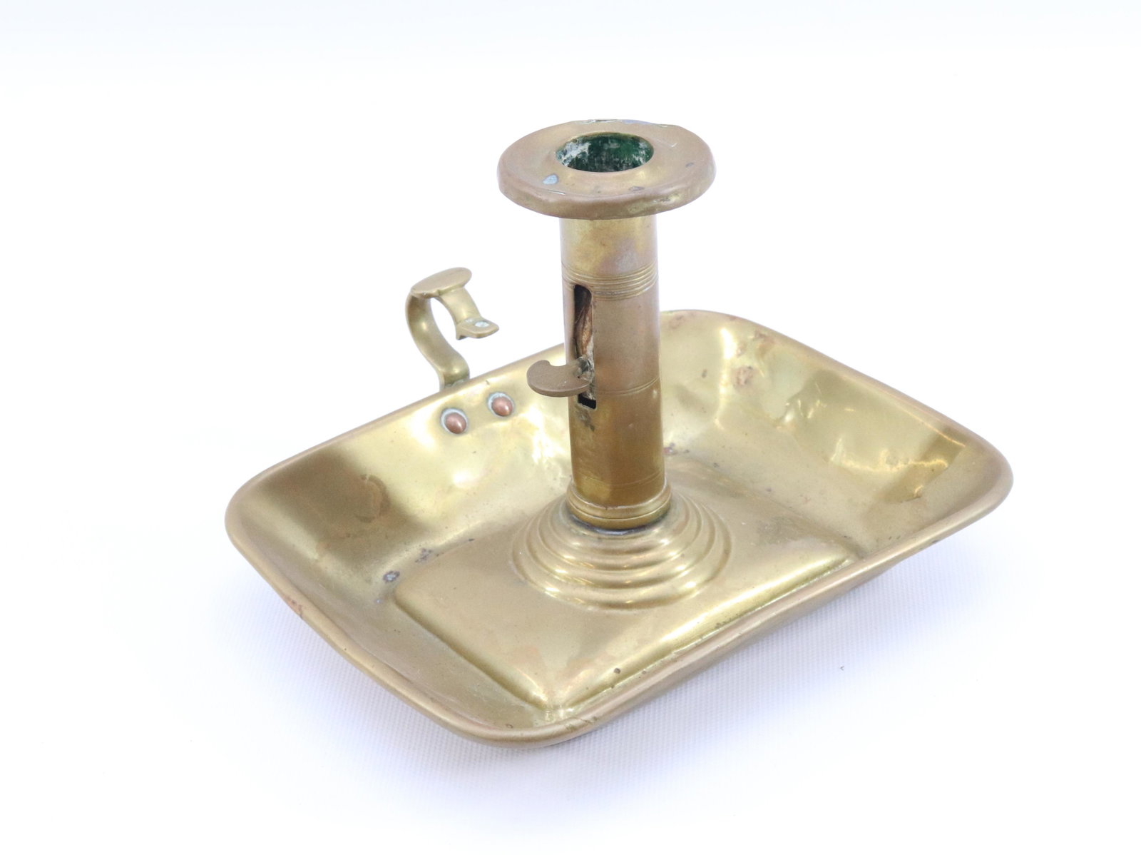 BRASS PUSH-UP CANDLE HOLDER: TRAY BASE WITH ADJUSTABLE HEIGHT LEVER AND FINGER LOOP FOR CARRYING Dimensions 5" X 6 1/2" PLEASE READ BEFORE BIDDING – PICKUP FOR THIS AUCTION WILL NOT BE UNTIL THE WEEK OF OCTOBER 25TH. PICK-U