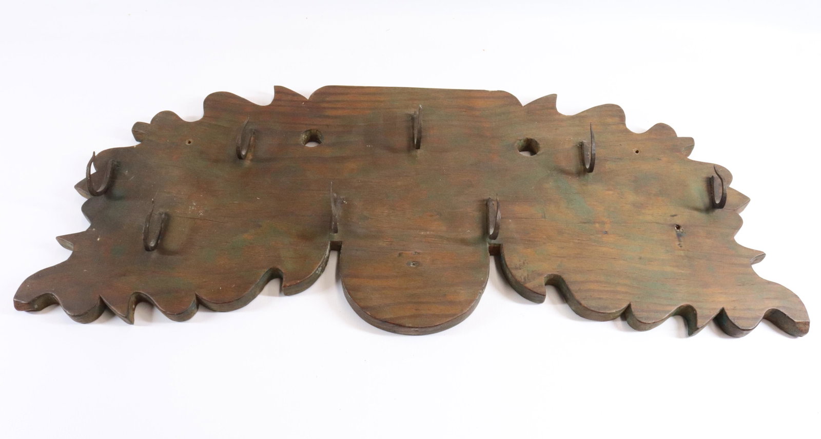 WOODEN GAMING RACK: CARVED WOODEN BACKING WITH EIGHT WROUGHT HOOKS Dimensions 10" X 25 1/2" PLEASE READ BEFORE BIDDING – PICKUP FOR THIS AUCTION WILL NOT BE UNTIL THE WEEK OF OCTOBER 25TH. PICK-UP WILL BE FROM 9:00