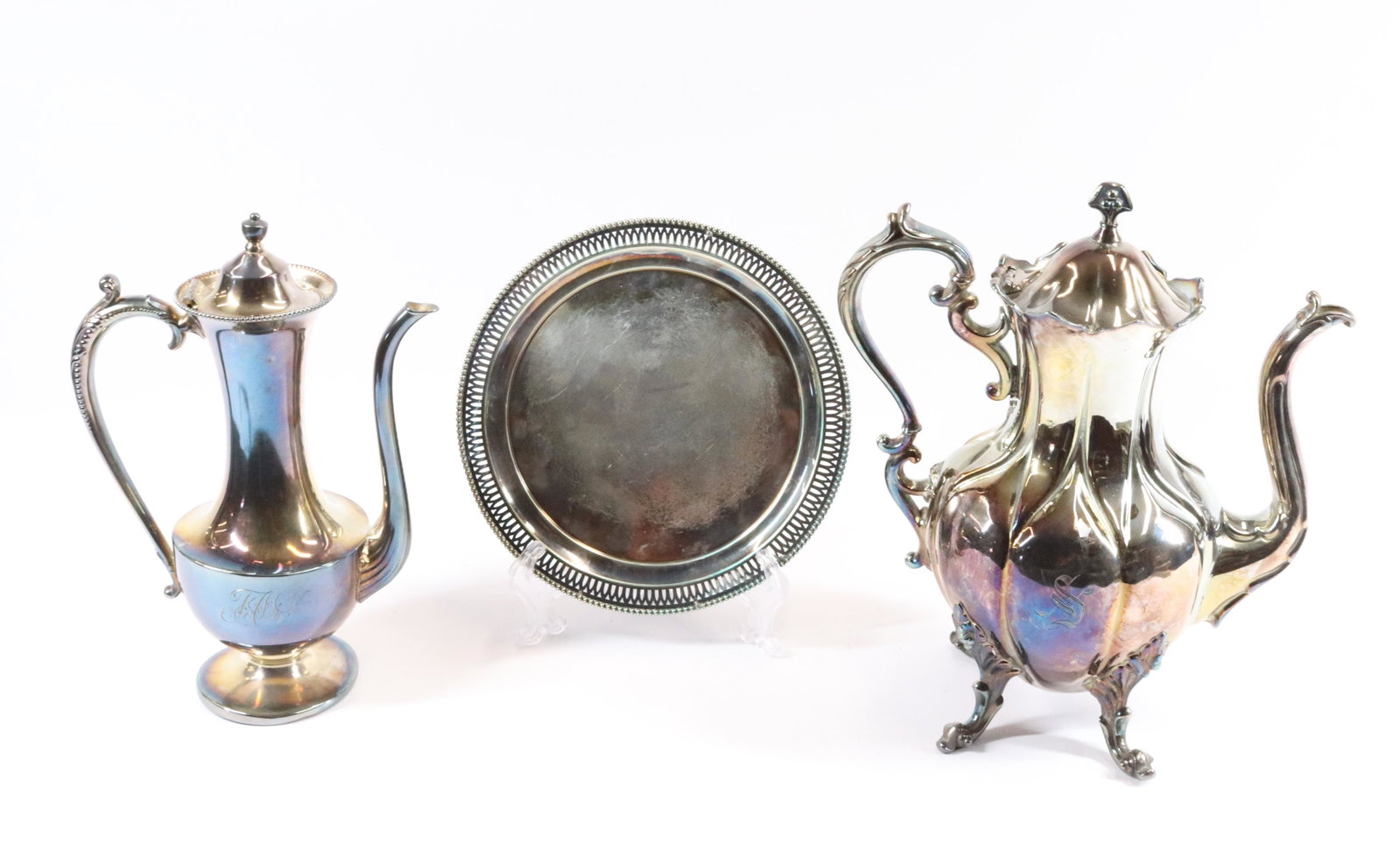 EARLY SILVER PLATE GROUPING: REED AND BARTON COFFEE POT, CHOCOLATE POT, AND ROUND TRAY SIZE: 8 1/2" - 10 1/2" - 11 1/2" PLEASE READ BEFORE BIDDING – PICKUP FOR THIS AUCTION WILL NOT BE UNTIL THE WEEK OF OCTOBER 25TH. PICK-UP WI