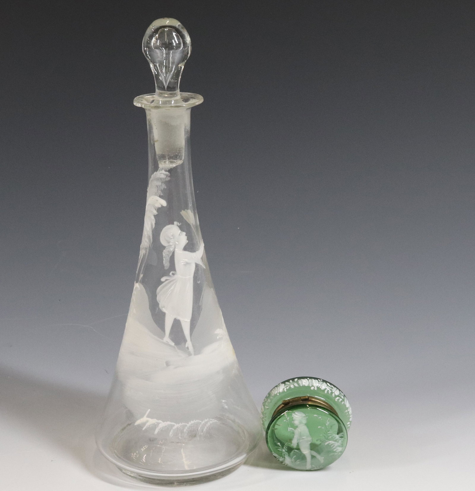 (2) PIECES OF MARY GREGORY TYPE GLASS: CLEAR DECANTER WITH GIRL AND BUTTERFLY NET, GREEN HINGED BOX WITH WITH SIZE: 10 1/2" AND 2 1/4" DIAMETER PLEASE READ BEFORE BIDDING – PICKUP FOR THIS AUCTION WILL NOT BE UNTIL THE WEEK OF OCTOBER 25