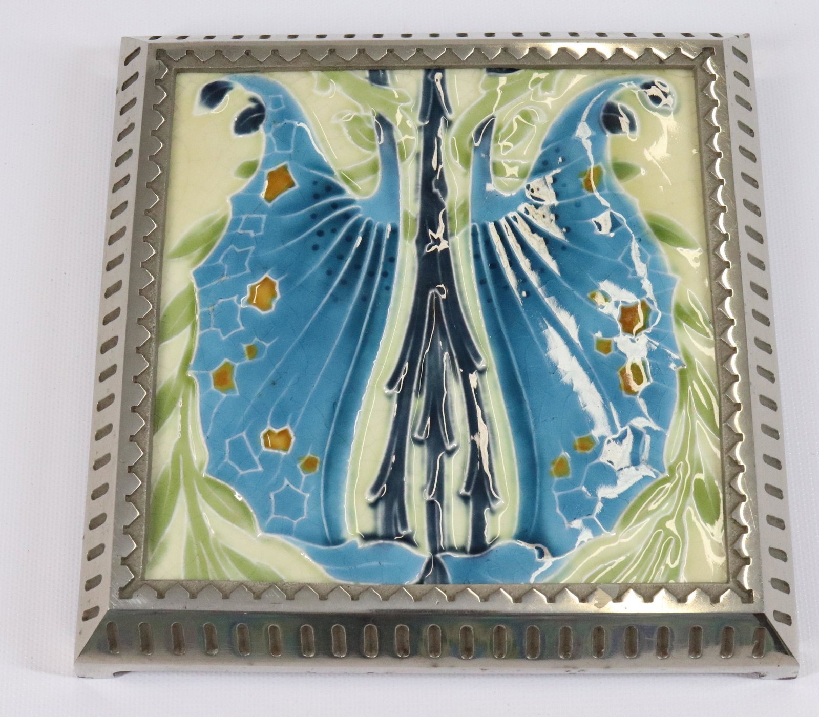 MINTONS ART DECO TILE: MOUNTED IN AN ART DECO NICKEL PLATED FRAME SIZE: 7" X 7" PLEASE READ BEFORE BIDDING – PICKUP FOR THIS AUCTION WILL NOT BE UNTIL THE WEEK OF OCTOBER 25TH. PICK-UP WILL BE FROM 9:00AM TILL 4:00PM – 