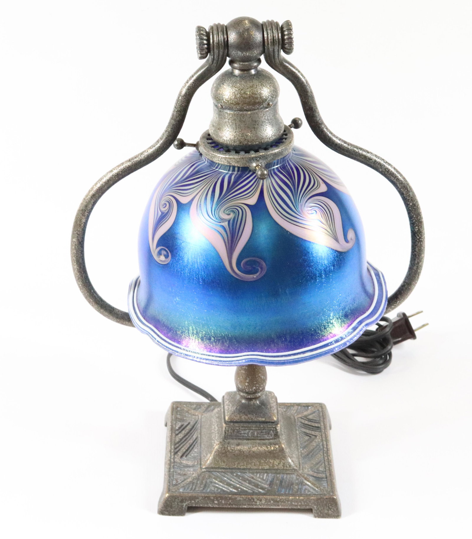 TIFFANY STUDIOS LAMP BASE: BRONZE BASE WITH SILVERPLATE TIFFANY STUDIOS BASE, NEW YORK #665, LUNDBERG ART GLASS SHADE WITH DEEP BLUE IRIDESCENT AND PULLED FEATHER DESIGN AND WHITE THREADING ON RIM SIZE: SHADE 4 3/4" X 7" - 13 1