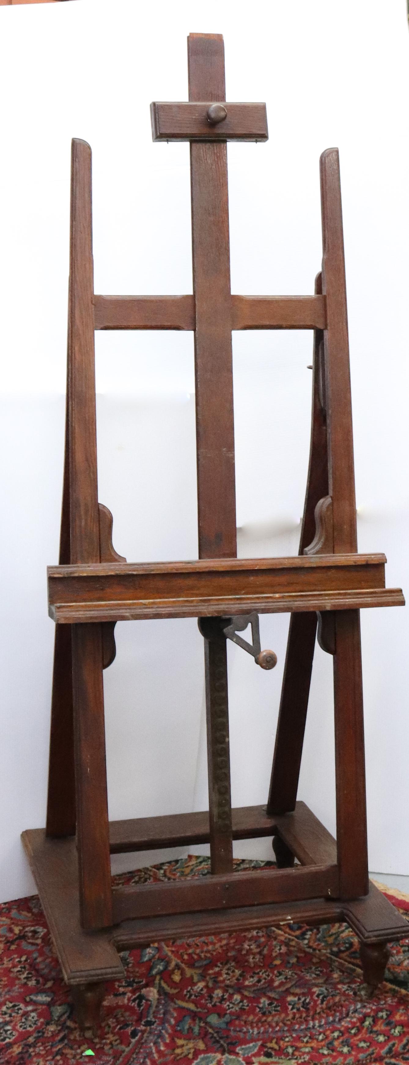 ANTIQUE ADJUSTABLE PAINTER'S EASEL: OAK AND BRASS WITH CAST IRON CRANK. CASTERS ON BOTTOM SIZE: 76" X 27" X 26" PLEASE READ BEFORE BIDDING – PICKUP FOR THIS AUCTION WILL NOT BE UNTIL THE WEEK OF OCTOBER 25TH. PICK-UP WILL BE FROM 9:00
