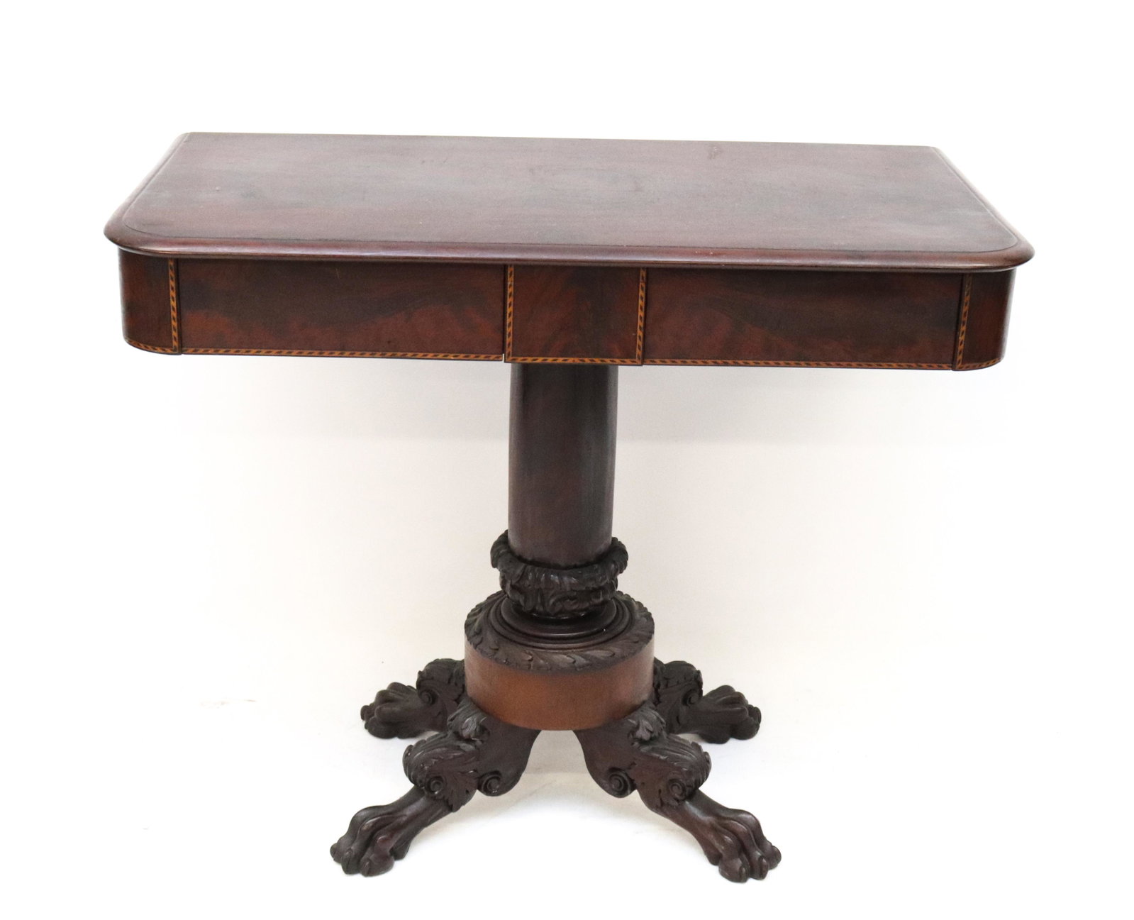 19TH C. CARVED MAHOGANY CONSOLE TABLE: TWO DRAWER TOP WITH BANDED INLAY. SUPPORTED BY CENTER COLUMN BASE WITH HAIRY PAW FEET SIZE: 32 1/2" X 40" X 20 1/2" PLEASE READ BEFORE BIDDING – PICKUP FOR THIS AUCTION WILL NOT BE UNTIL THE WEEK OF