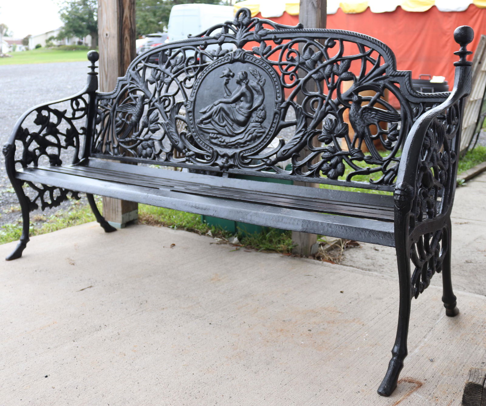 PAINTED CAST IRON GARDEN BENCH: CENTER MEDALLION WITH WOMAN AND BIRD. VINE AND BIRD MOTIF THROUGHOUT. HOOF FEET. HEAVY WEIGHT. (NOT ANTIQUE) SIZE: 43" X 72" X 17" PLEASE READ BEFORE BIDDING – PICKUP FOR THIS AUCTION WILL NOT BE UN
