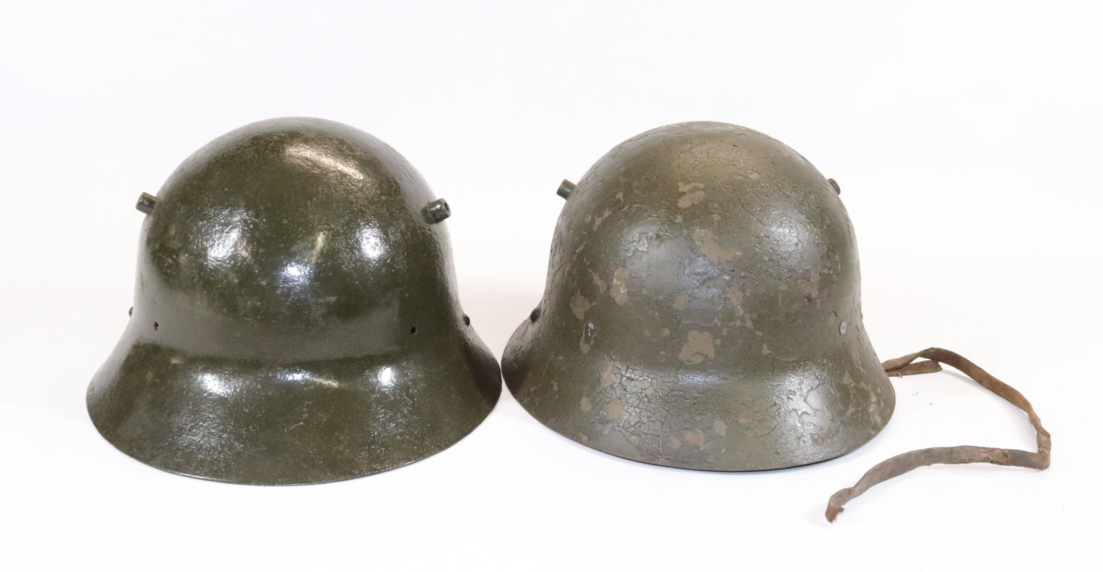 (2) WWI SPANISH MILITARY HELMETS: ONE WITH LINER AND STRAP SIZE: 11 1/4" L