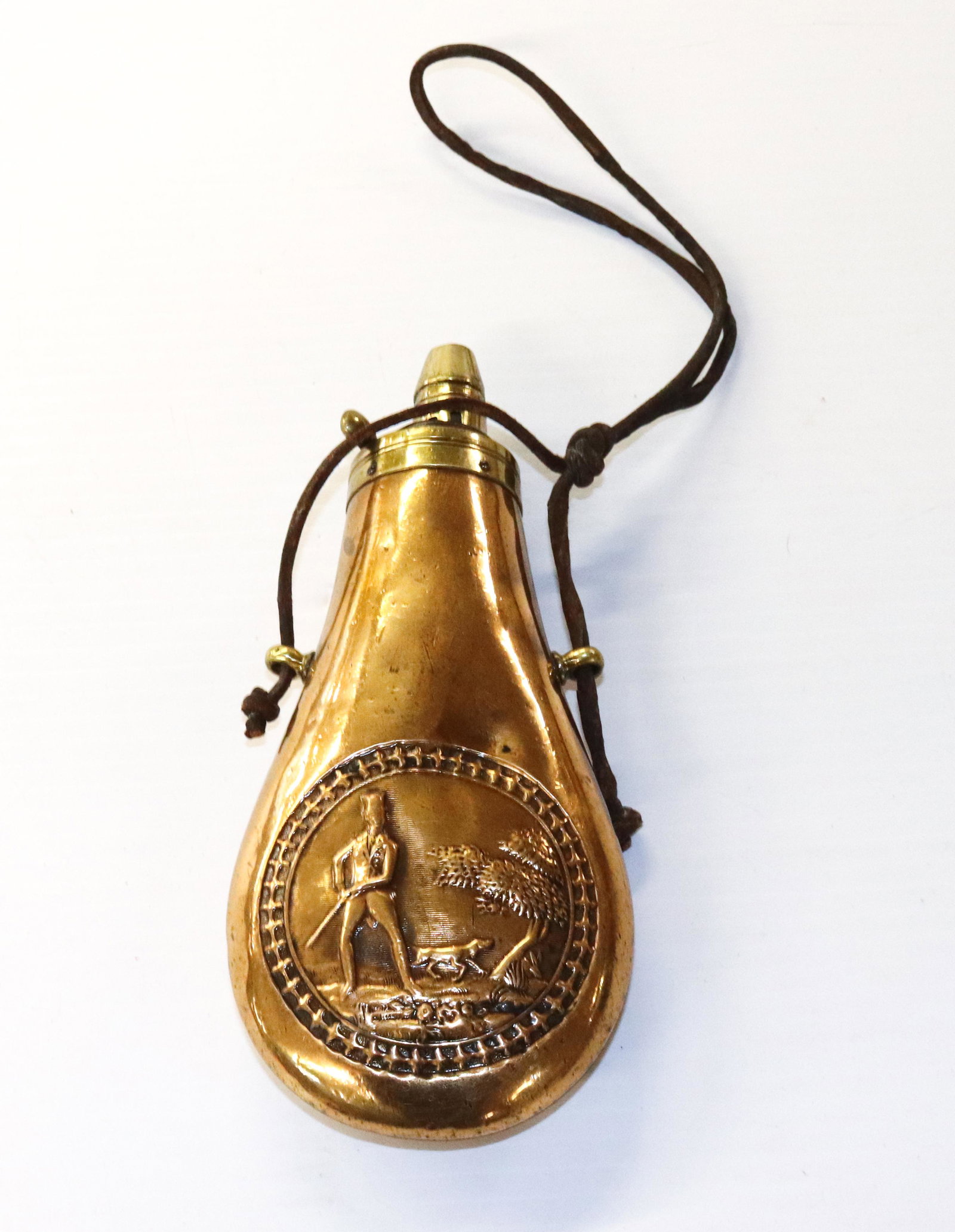 ANTIQUE POWDER FLASK: BRASS WITH HUNTER, DOG AND TREE SCENE-7"