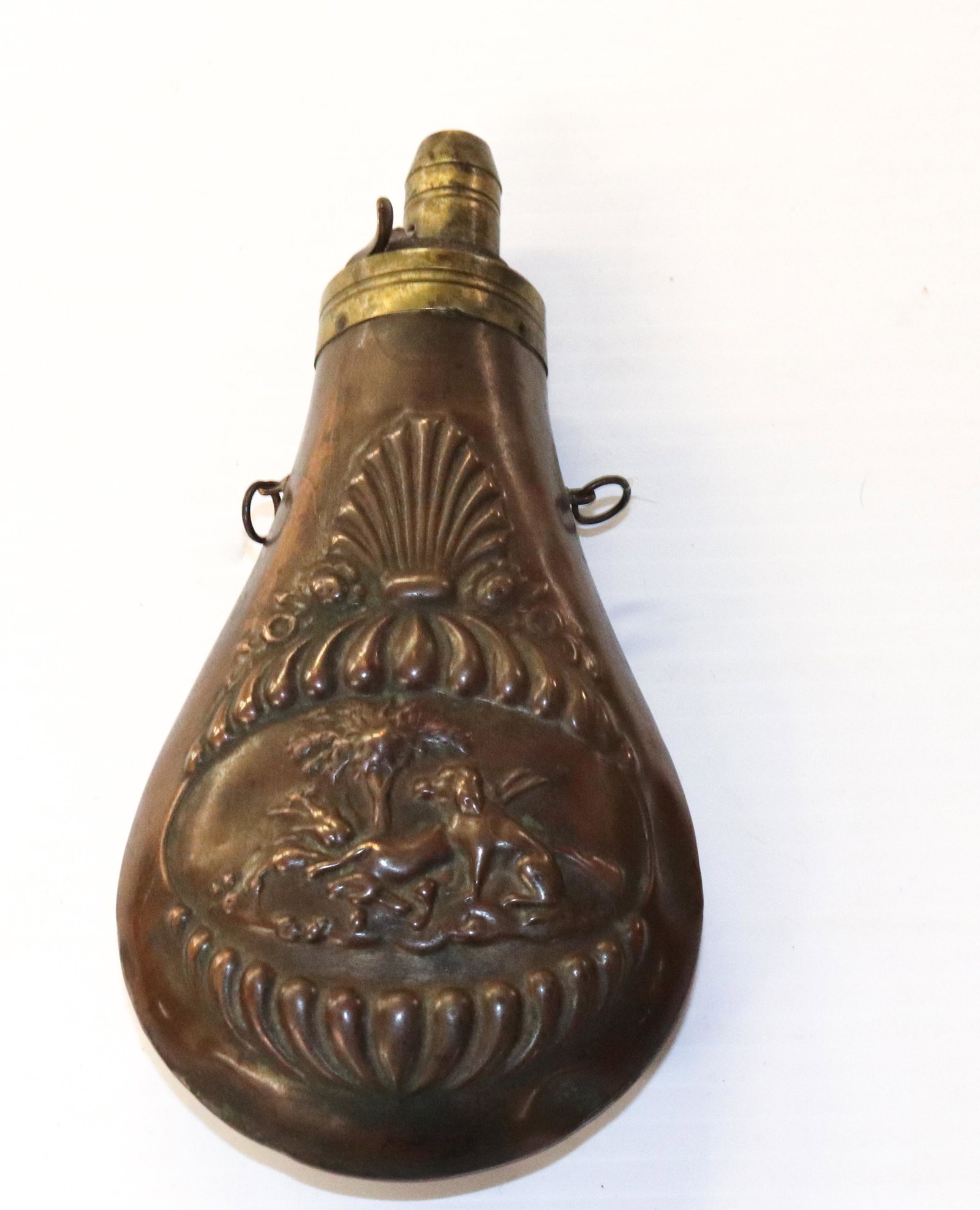 ANTIQUE POWDER FLASK: BRASS- EMBOSSED WITH A RABBIT AND DOG-7"