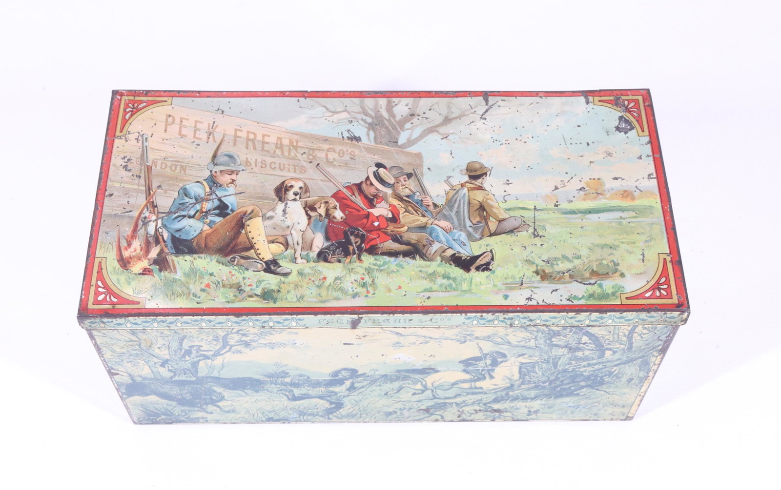 PEEK FREEN & CO. HUNTERS BISCUIT TIN: HINGED LID WITH VARIOUS HUNTING SCENES ON ALL SIDES 4 1/4" X 9 1/4" X 4 1/4"