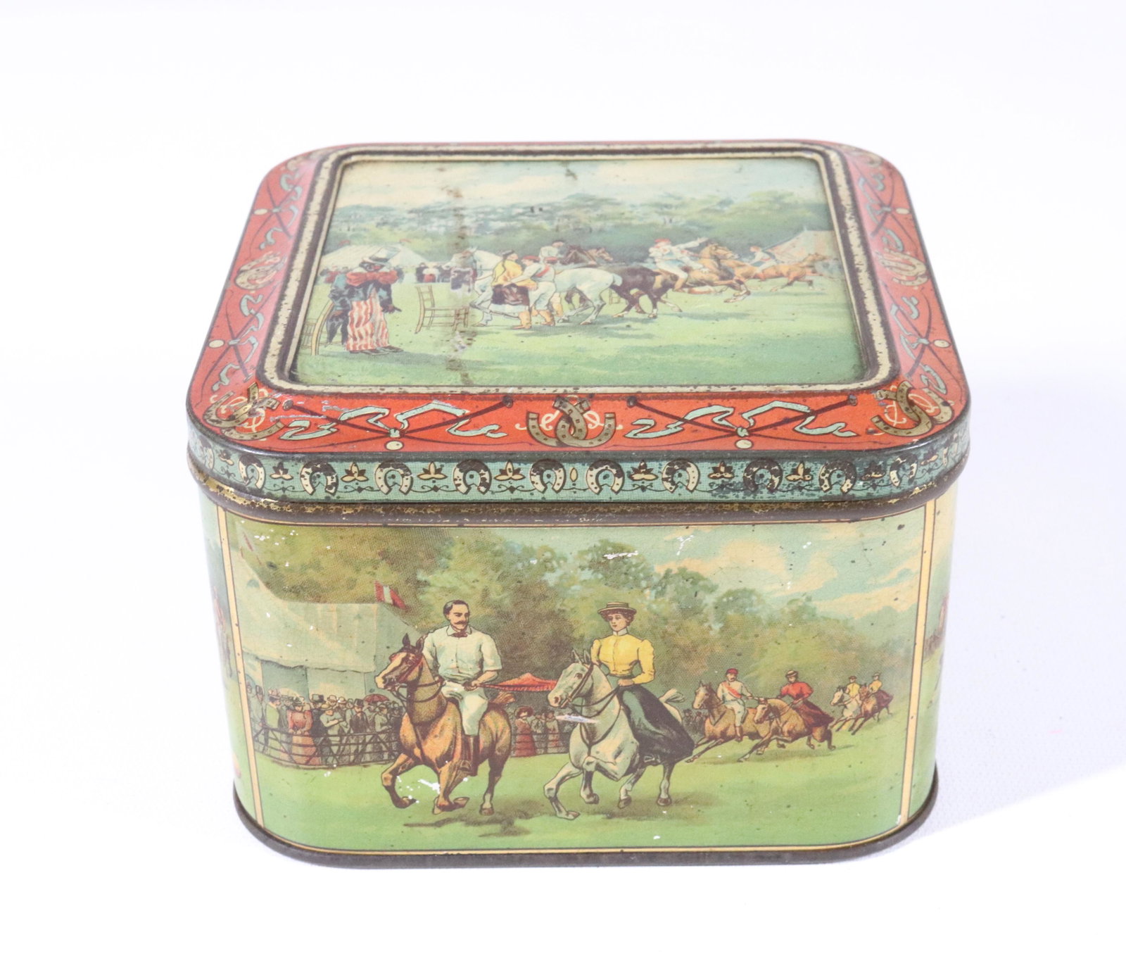 HUNTLEY & PALMERS HORSE THEMED BISCUIT TIN: DEPICTS POLO, CLOWNS ON HORSES AND MORE. HINGED LID AND MRKD. ON BOTTOM 3 1/2" X 5 1/4"