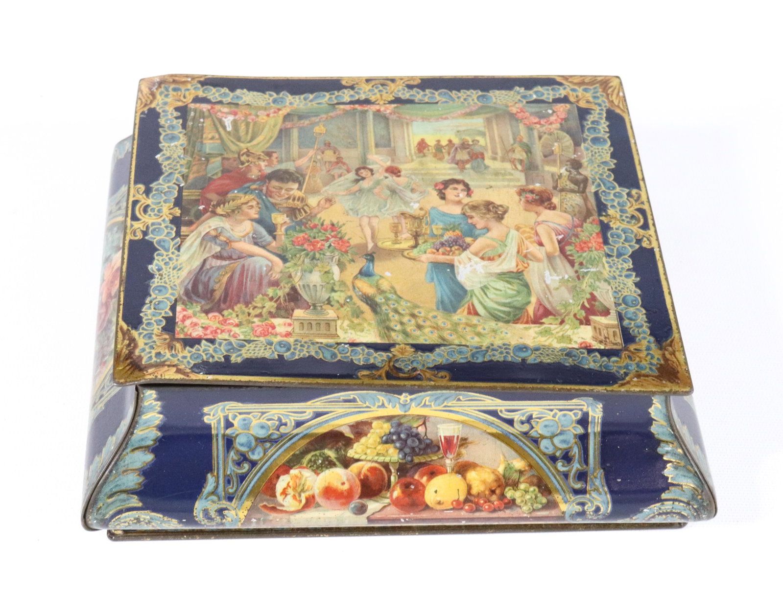 CWS TIN LITHO BISCUIT TIN: HINGED LID WITH ELABORATE GREEK CELEBRATION. MRKD. ON BOTTOM 2 3/4" X 8 1/4" X 7 1/2"